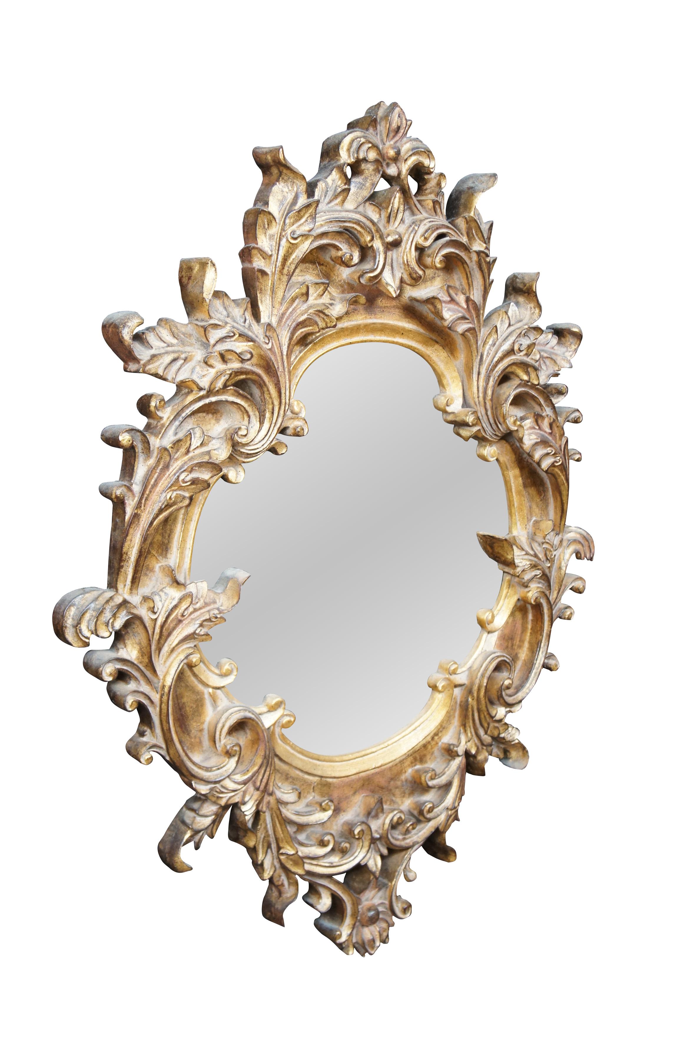 Vintage Raschella Collection wall or vanity mirror featuring Italian Regency styling with ornate Baroque / Rococo florals and acanthus leaves.  Finished in Plum Gold.  The glass is antiqued

Raschella Collection Inc, founded in 1999, is an importer