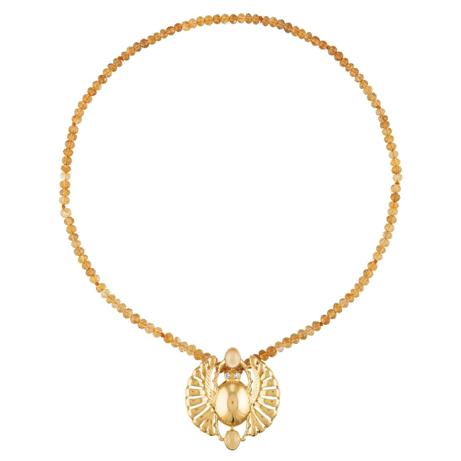 This necklace in precious metals and semiprecious stones is a timeless statement with the open winged scarab pendant. The pendant comes in yellow gold vermeil and Sterling silver. Its all-around stones feature vivid color colors with cabernet red