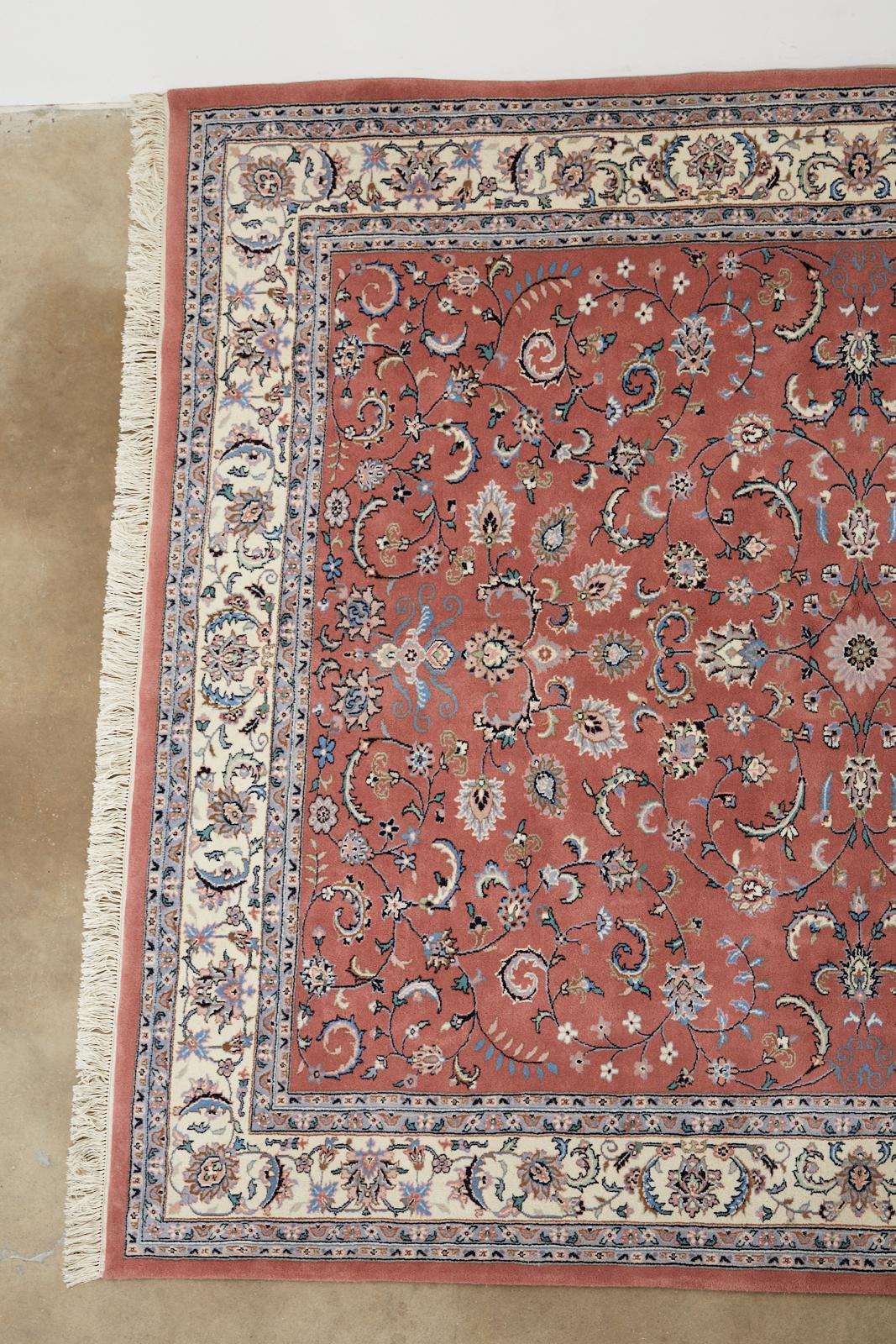 Fine Indo Persian Kashan style hand knotted wool rug featuring a colorful unique raspberry field. The carpet is decorated with Classic, floral vine motifs and palmettes. Lovely open design pattern that allows the vivid colors to stand out boldly.