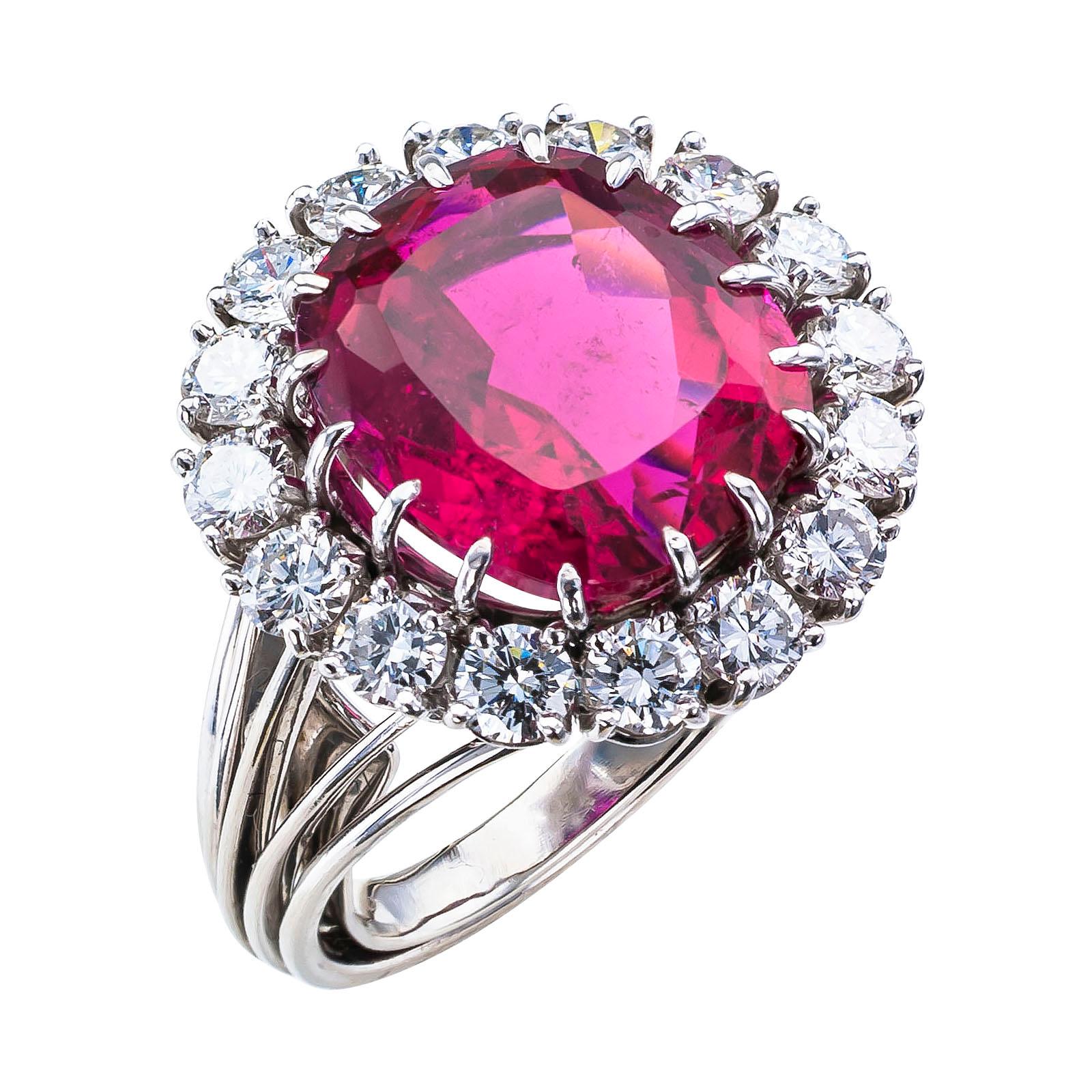 Raspberry tourmaline diamond and white gold cocktail ring by Gubelin circa 1960.

DETAILS:
GEMSTONES:  one raspberry jammy red color, cushion-shaped tourmaline weighing approximately 8.14 carats.
DIAMONDS:  sixteen round-brilliant-cut diamonds