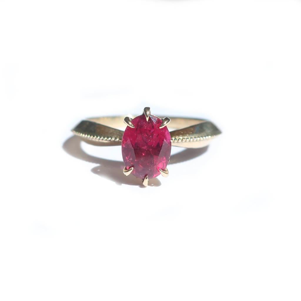 The play of color in the Rubelite Tourmaline makes this a truly unique and timeless piece. The raspberry pink stone has hues of red and orange that are picked up in the light. The tapered band with beading is a nod to vintage pieces and the claw