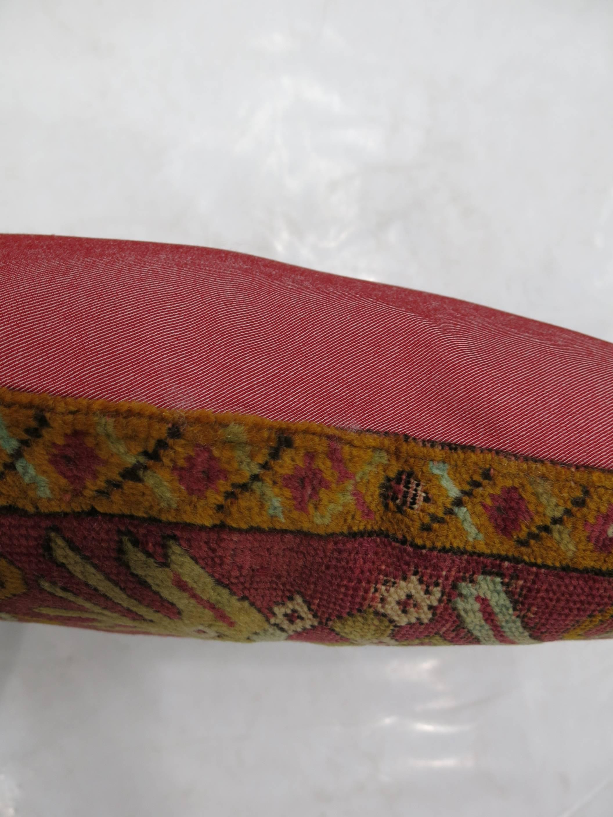 Pillow made from a 19th century Turkish Ghiordes rug backed in red cotton. Measures: 16'' x 18''.