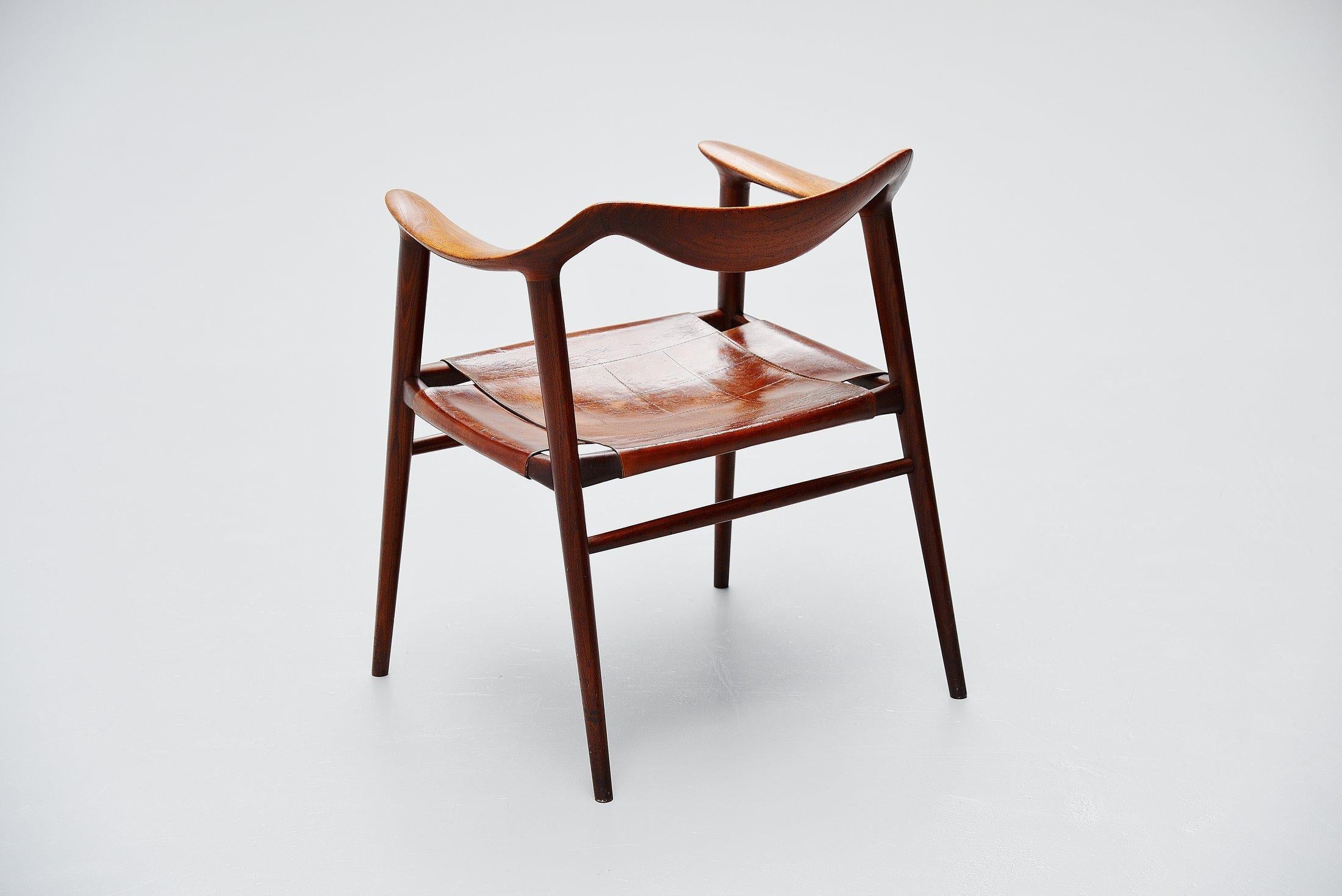 Stunning sculptural armchair designed by Rastad and Relling and manufactured by Gustav Bahus & Eft, Norway 1954. Very nicely shaped armchair so called 'Bambi'. The chair is made of solid teak wood and has a very nice leather stitched seat with