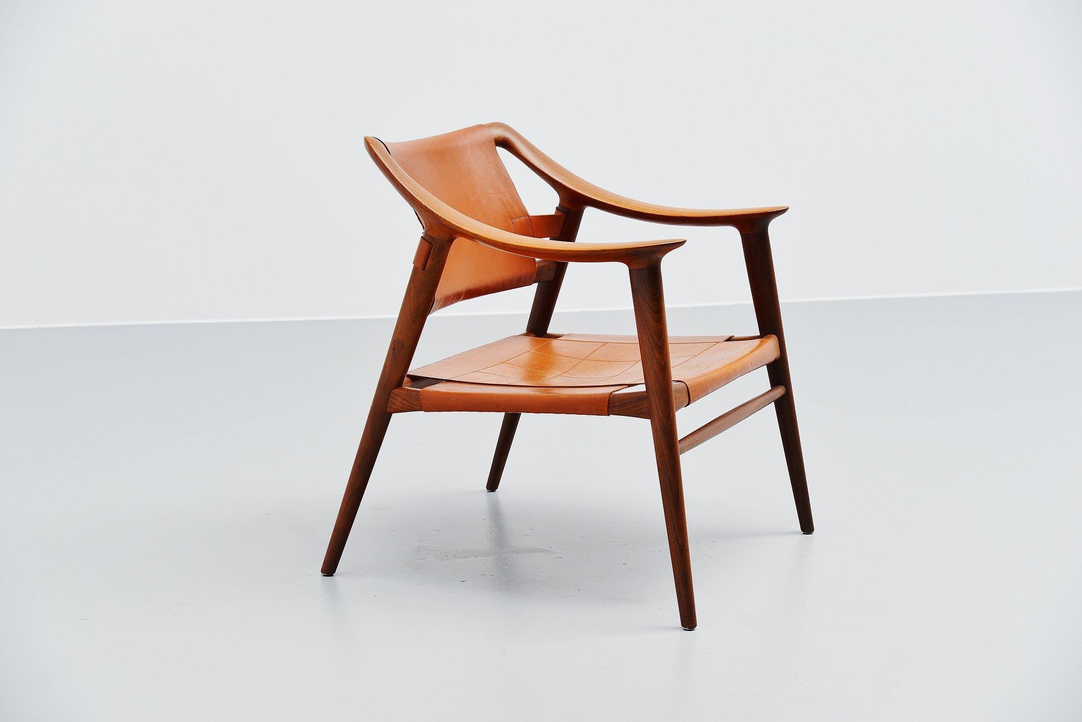 Stunning sculptural lounge chair designed by Rastad and Relling and manufactured by Gustav Bahus & Eft, Norway, 1954. Very nicely shaped lounge chair so called ‘Bambi’. The chair is made of solid teak wood and has a very nice cognac leather stitched