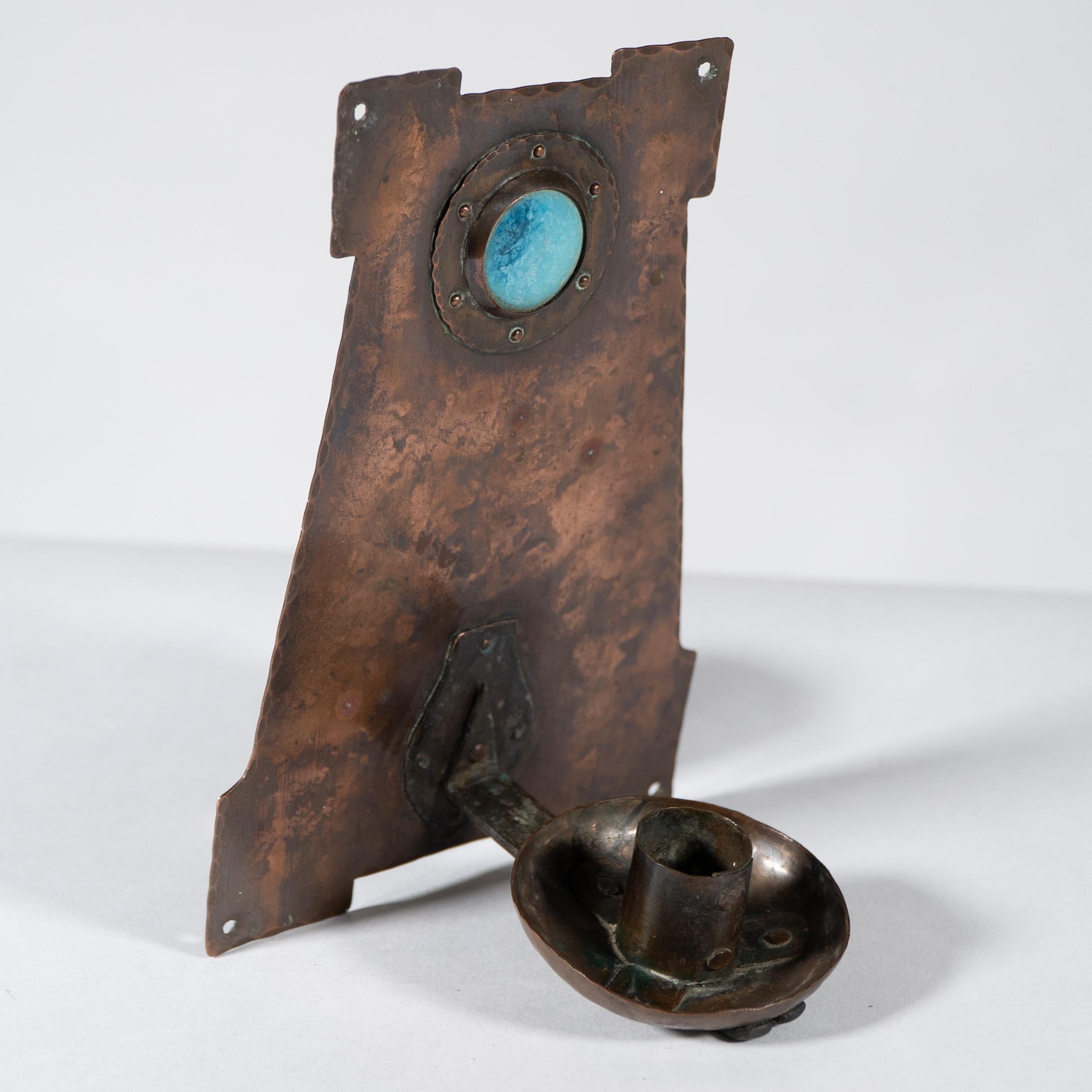 Richard Rathbone attributed. An Arts and Crafts 'A frame' copper wall sconce with riveted Ruskin Jewel to the top and a fine hand wrought iron support for the candle holder. The edges of the main frame are hammered alternatively in a delightful way