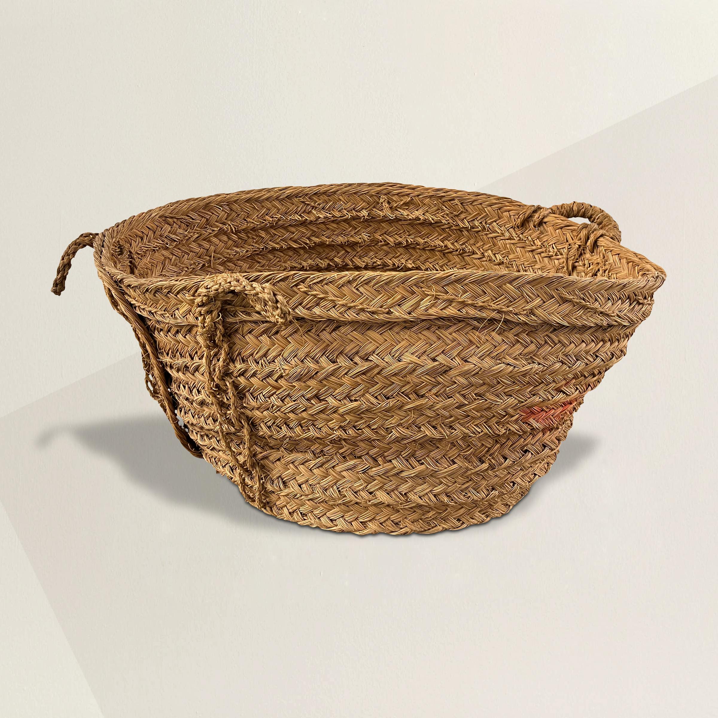 A rather large vintage French handwoven vineyard basket from Bordeaux, with three loop handles and a fun wonky shape. Perfect for storing extra blankets and pillows under a console in your bedroom, or filled with kid's toys in the playroom.