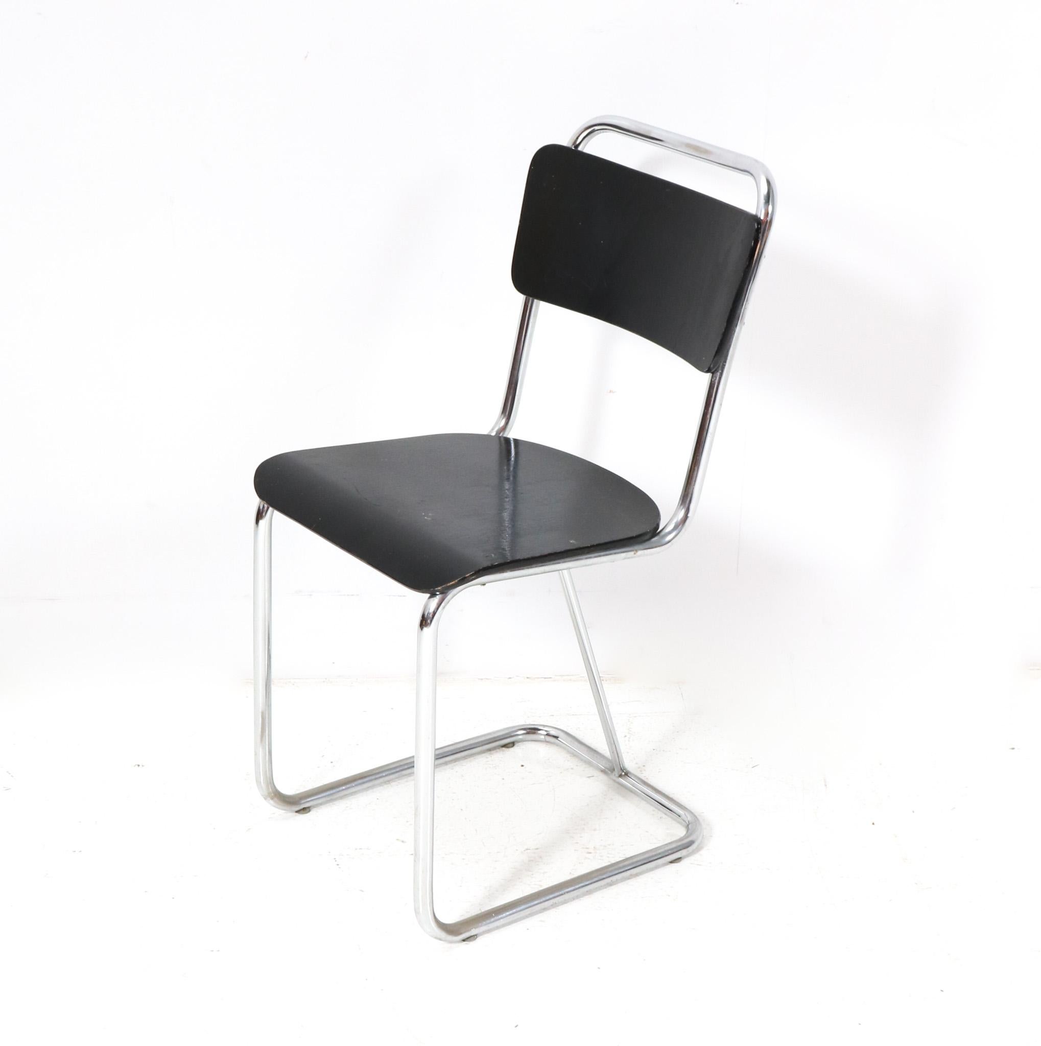 Stunning and elegant Rationalist Bauhaus side chair.
Striking Dutch design from the 1930s.
Chrome tubular steel frame with original black lacquered back and seat.
This wonderful Rationalist Bauhaus side chair is in good condition with minor wear