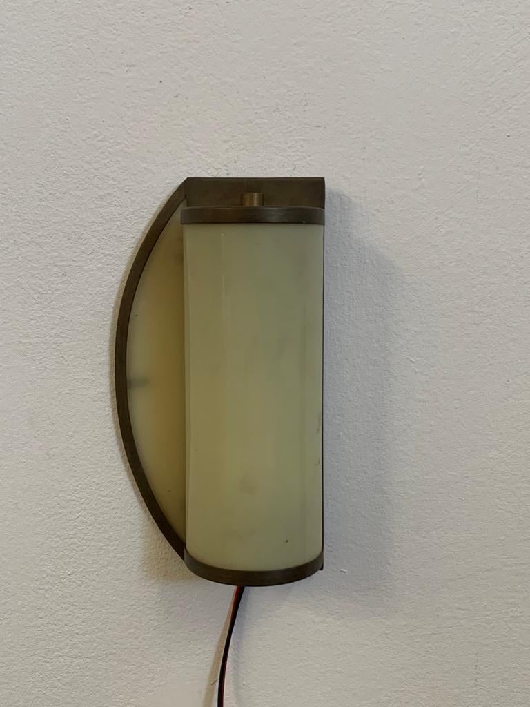 Rare rationalist ship's wall light in brass and ivory opaline glass.
Electrical system recently redone. Structure never touched, brass has taken on patina and all the charm of time.
