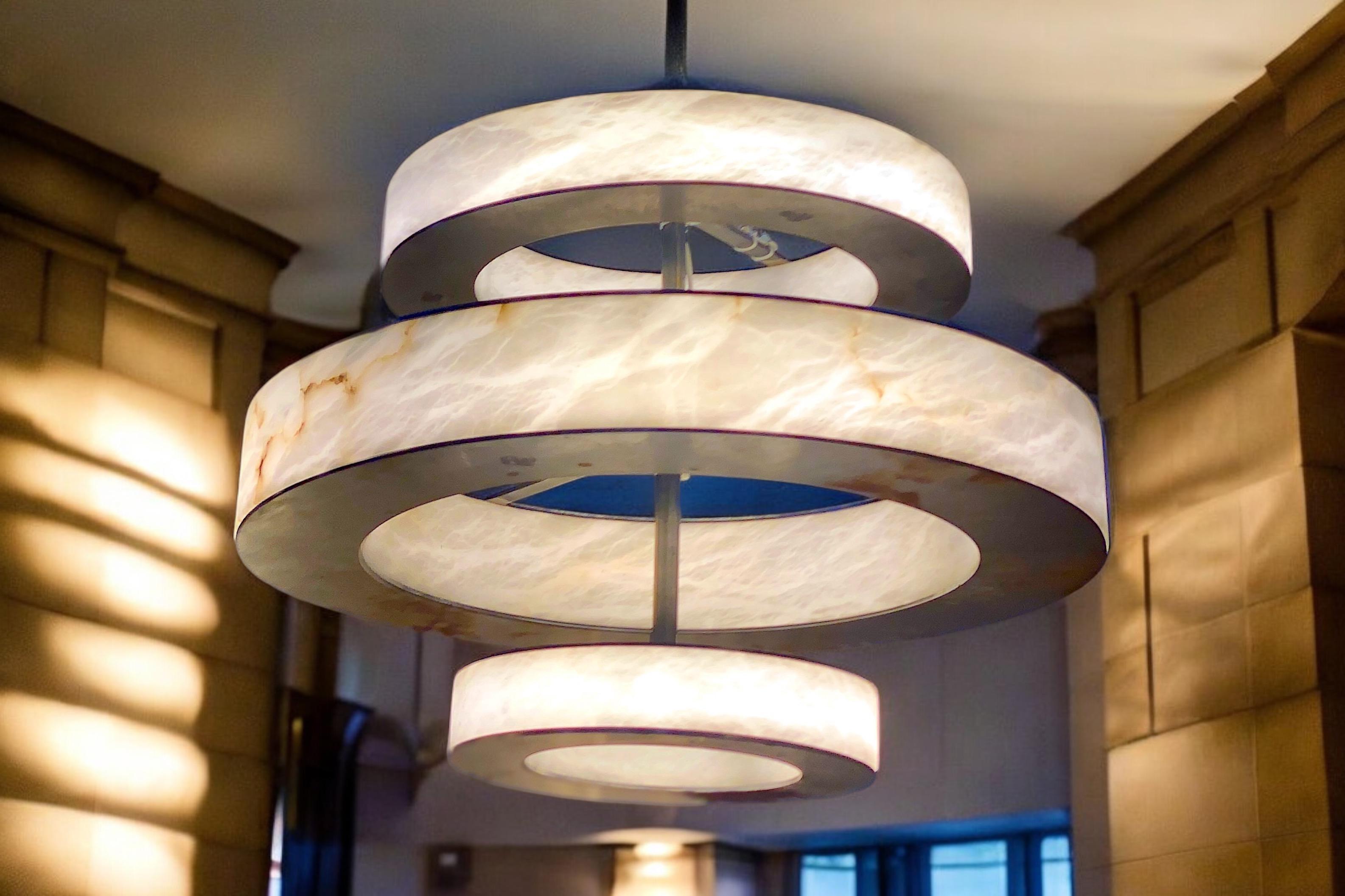 Contemporary Italian alabaster marble  chandelier with iron structure. 
 In the  manner of Roman Rationalist style. 
Hight cm 60 plus iron rod . The hight of the rod we can customize on request.

Exclusive production of Tuscany alabaster, handmade