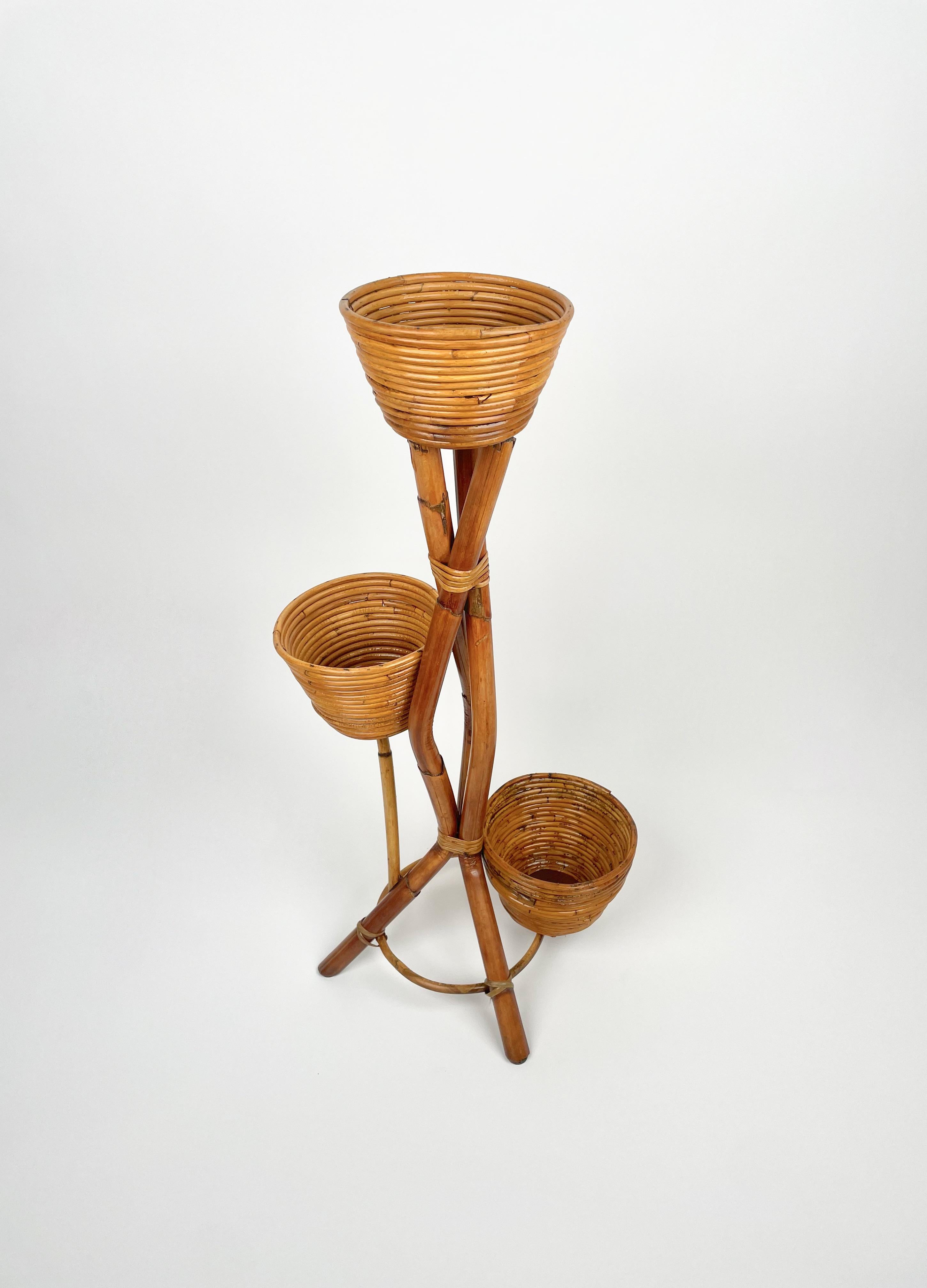 Flower stand or plants holders in rattan and bamboo featuring three vases.

Bamboo / rattan has been polished by a professional restorer.

Made in Italy in the 1960s.
 