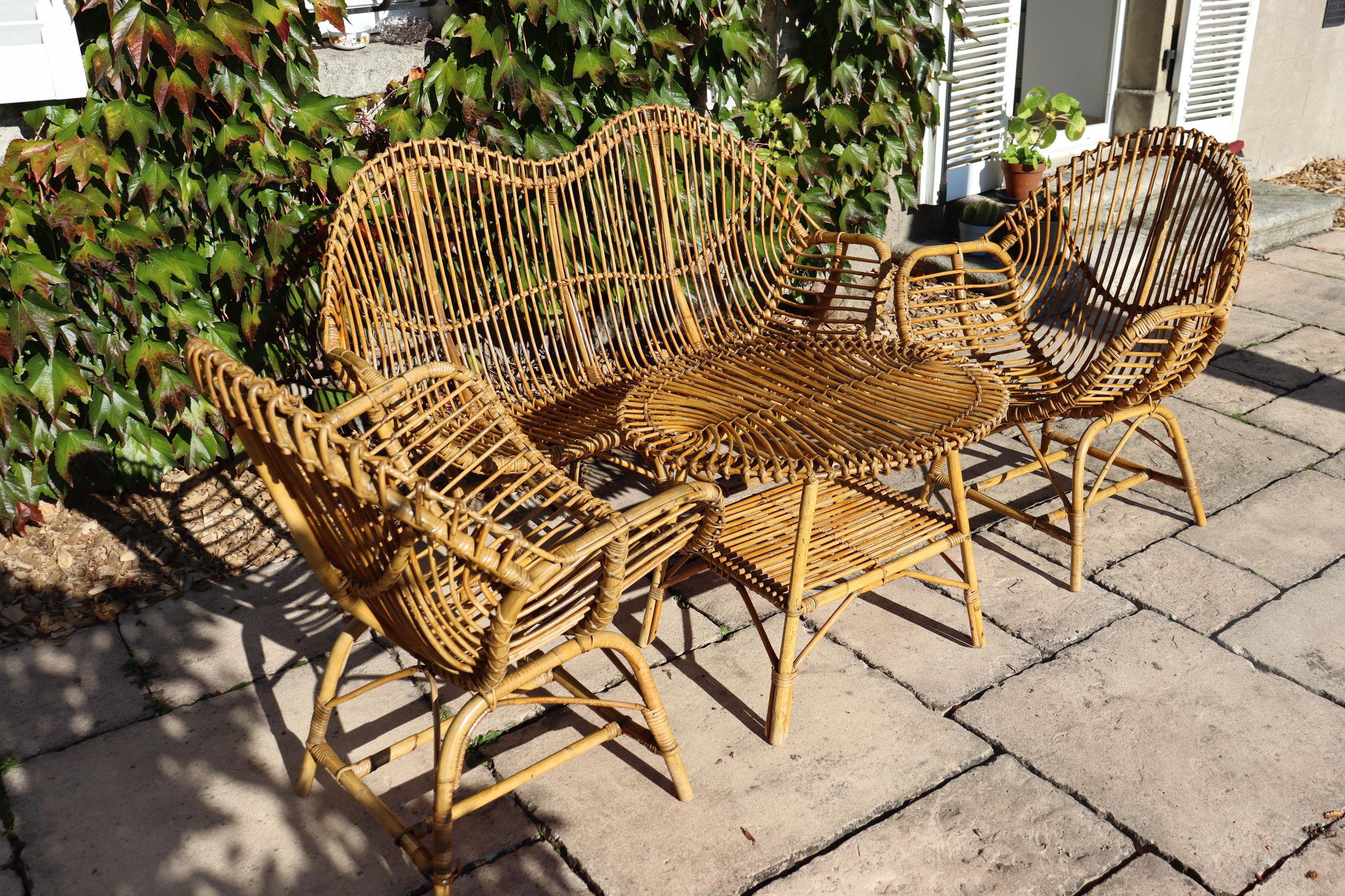 rattan and bamboo living room from the 60s made in Italywork attributed to Franco Albini in very good condition consists of a coffee table, a bench, two armchairscoffee table: 54 cm high, 74 cm long, 64 cm deeparmchairs: 90 cm high, 68 cm wide, 61