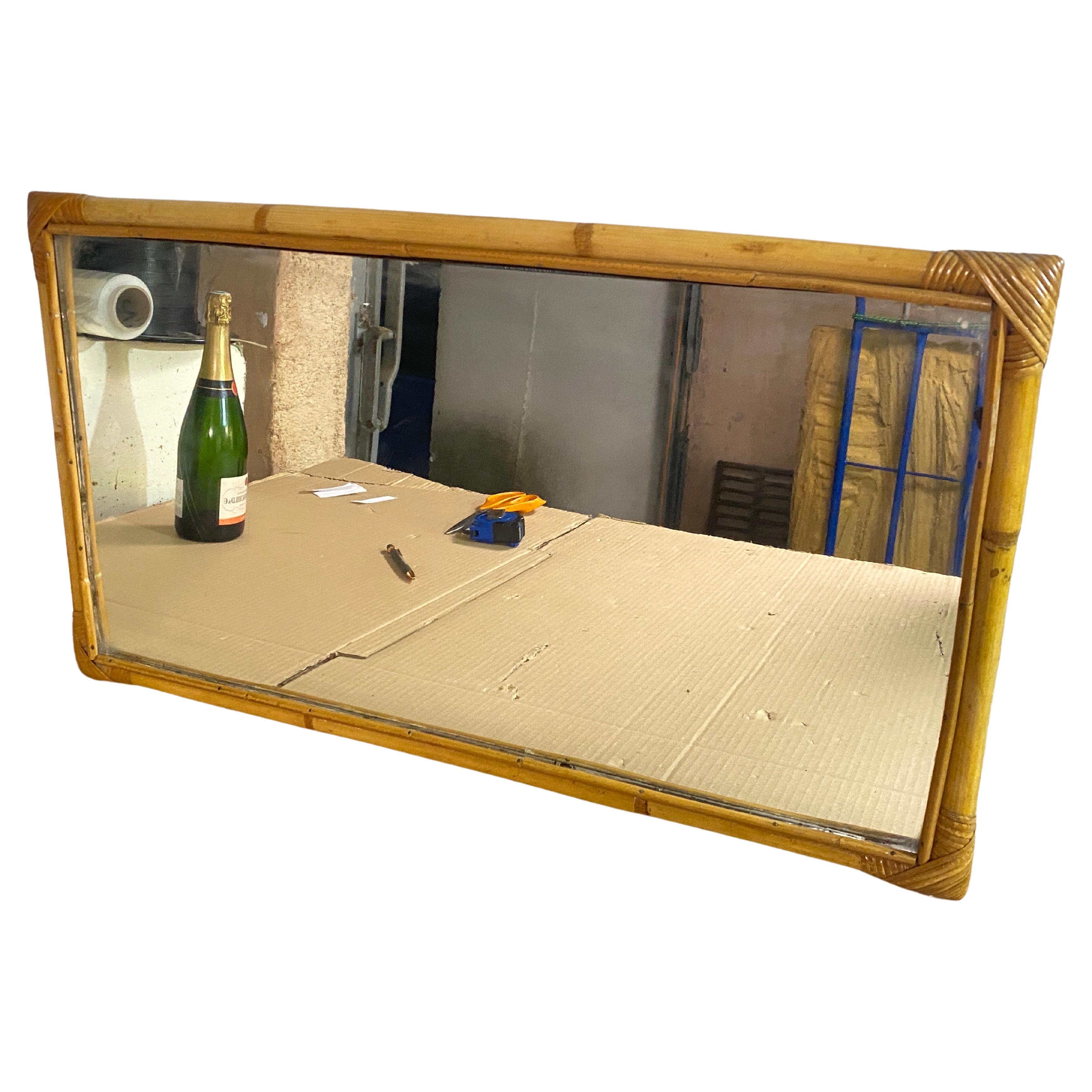 Beautiful rectangular wall mirror in bamboo and rattan. 

The corners are lashed together and protected with rattan strands. 

Incredibly stylish, it can add a real focal point to any room with considerable decorative effect. 

Made in Italy in the