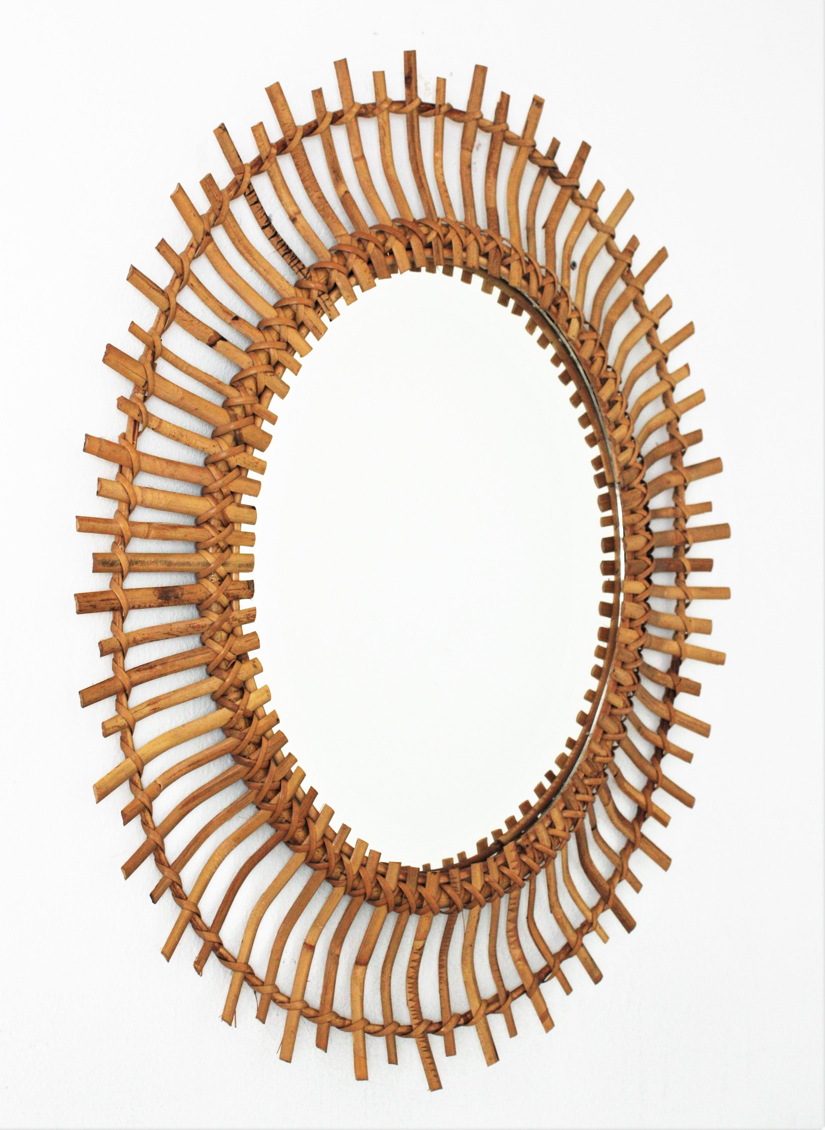 Amazing bamboo and rattan sunburst oval mirror. Handcrafted in Spain, 1960s.
It has all the taste and freshness of the Mediterranean Coast.
Lovely placed alone or as a part of a rattan mirrors wall composition.
This rattan oval mirror is the