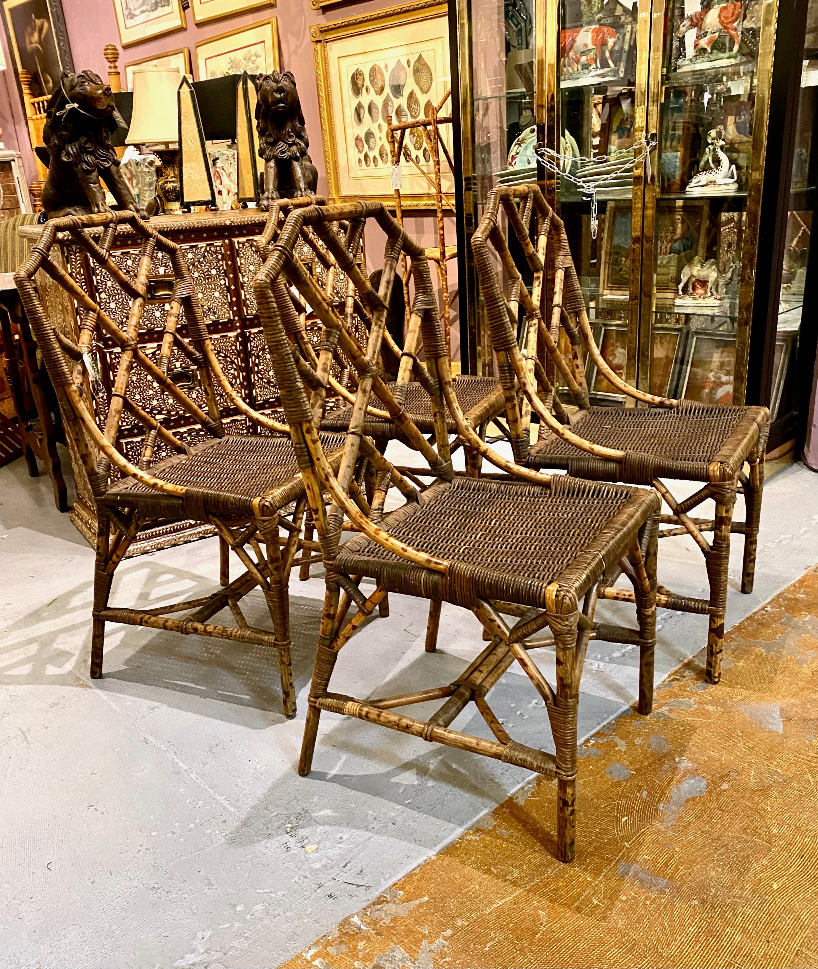 This is a unique set of 4 Bamboo and Wicker Chinese Chippendale Side Chairs that most probably date to c 1930-1940. The chairs, although iconic in form, feature leopard/oil spot bamboo frames and wicker seats which are finely wrapped in rattan at