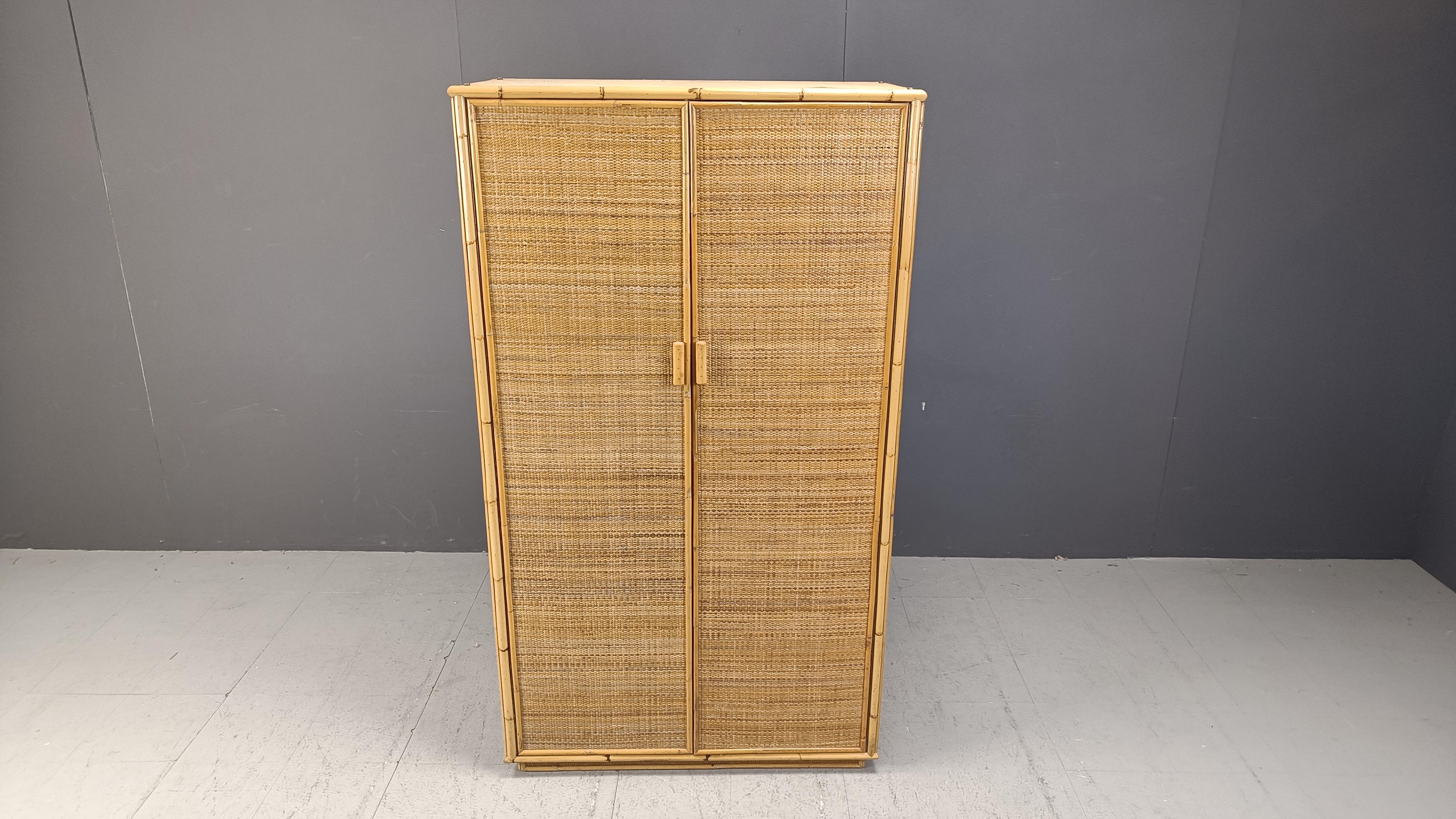 Vintage bohemian wardrobe with two doors made from a bamboo frame and rattan doors.

Very good condition

1970s - italy

Dimensions:
Height: 177cm
Width: 100cm
Depthh: 53cm

Ref.: 25022602