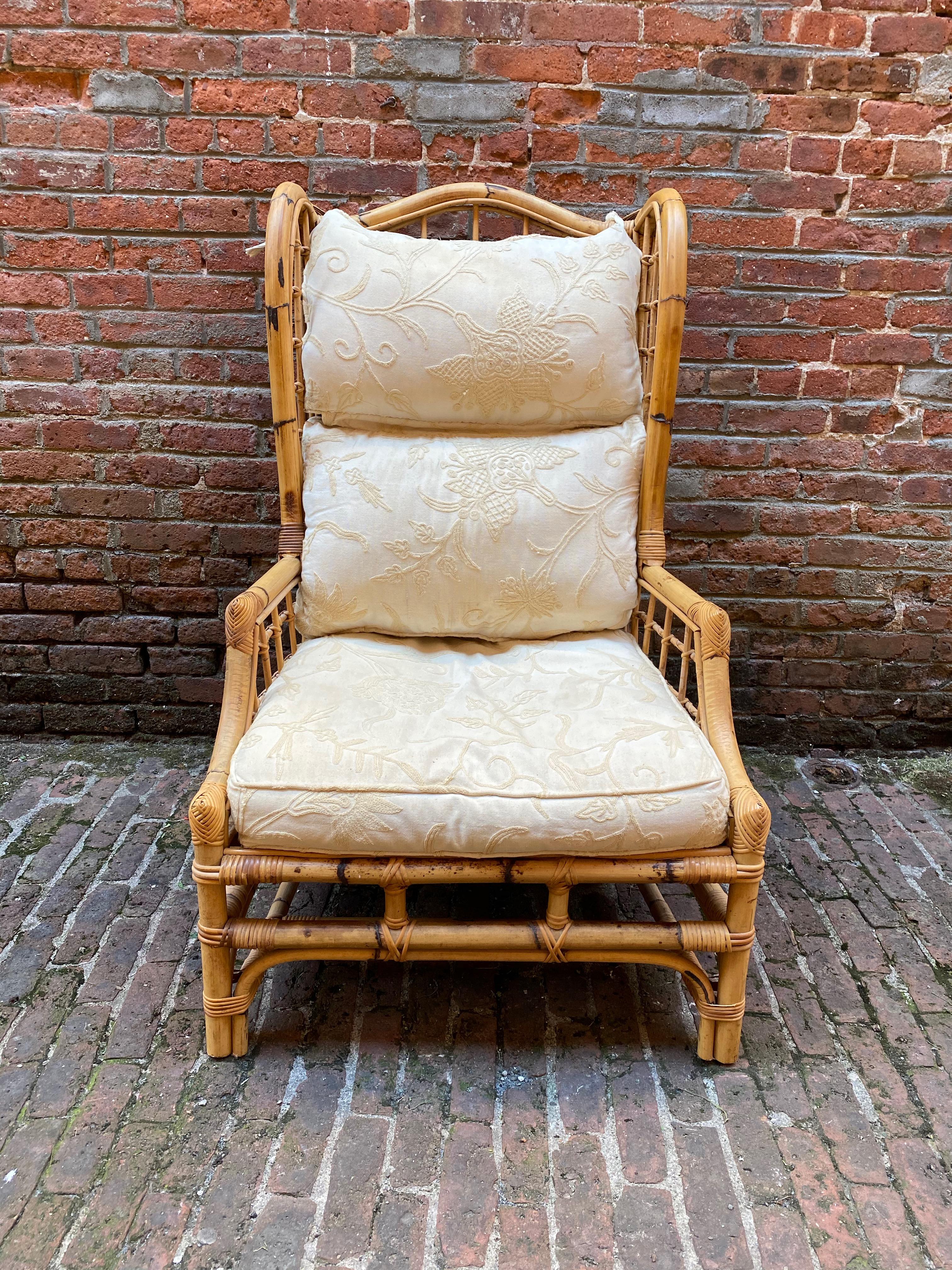 Rattan and bamboo wingback chair with cushions, circa 1975. Lovely sturdy and durable rattan frame with embroidered seat and back cushions. Lattice designed back and sides. Very good condition with some minor staining on the cushions due to age and