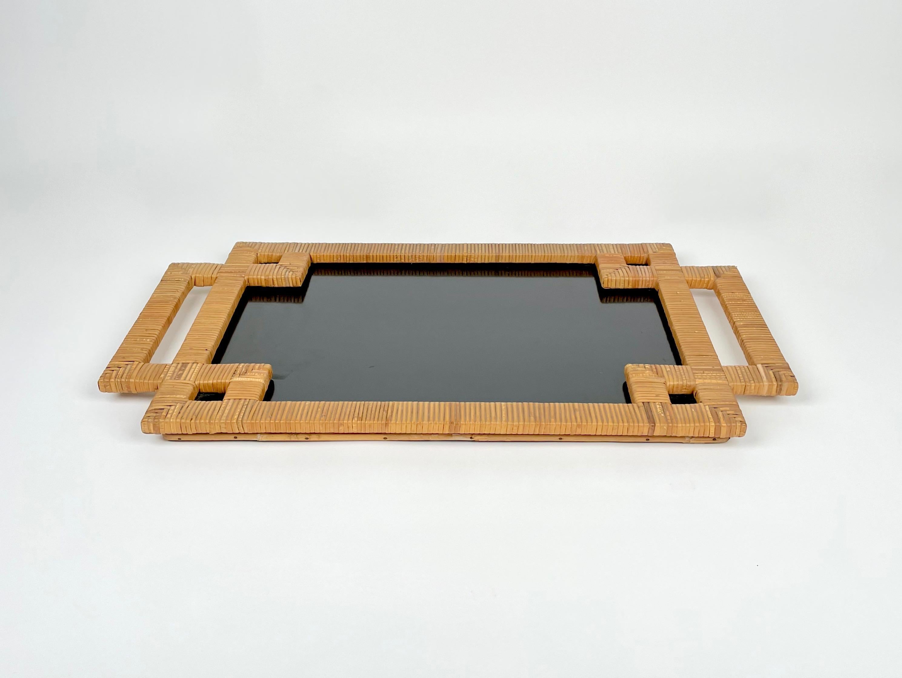 Rectangular serving tray in black laminate framed by rattan with handles. Made in Italy in the 1970s.