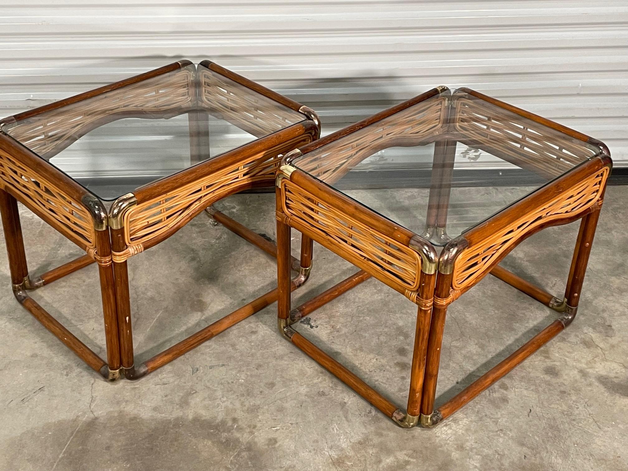 Pair of rattan side tables feature brass joints and woven pencil reed skirts. Good condition with imperfections consistent with age (see photos).

  