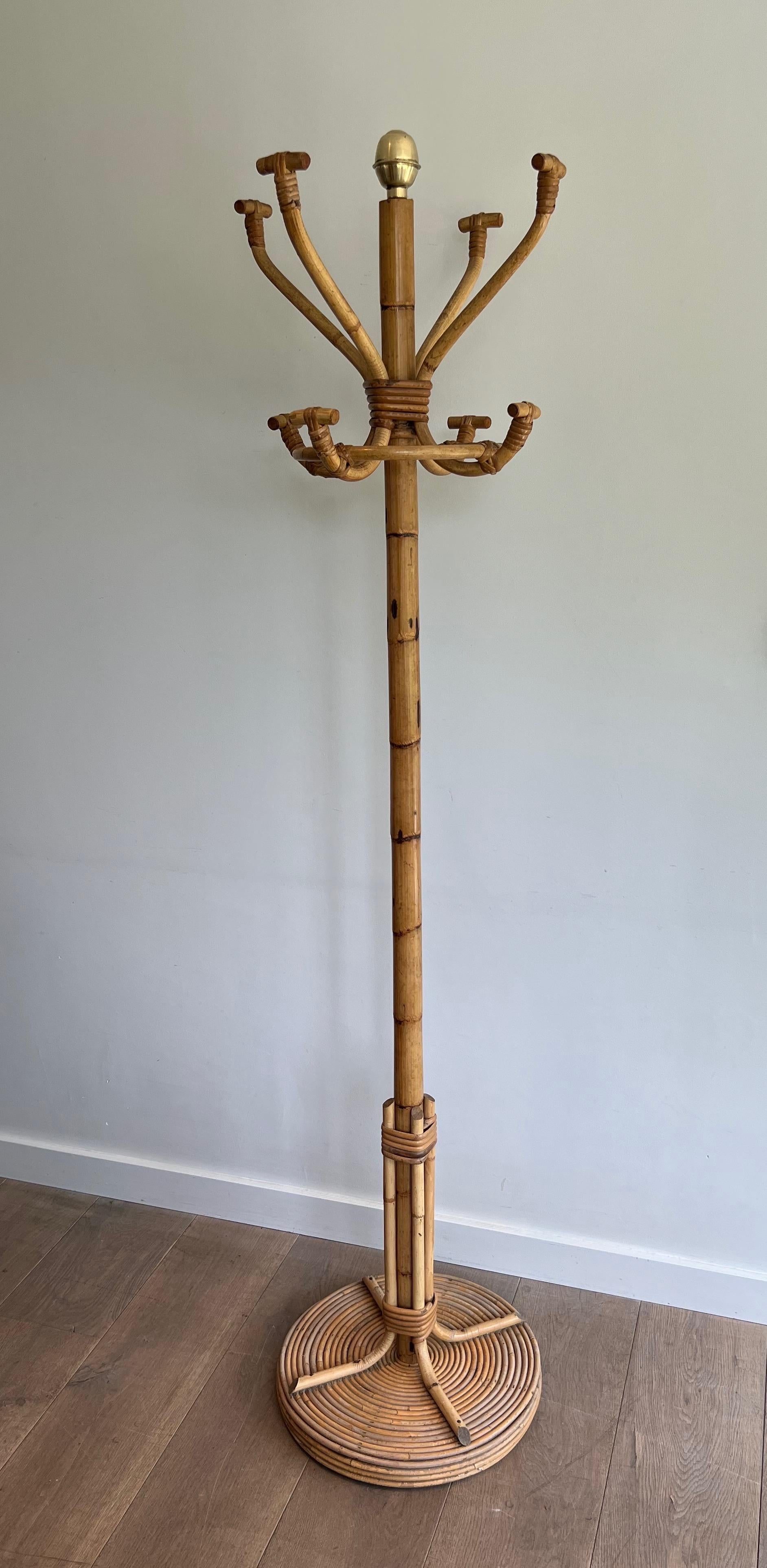This very nice and decorative coat rack on stand is all made of rattan. This is a French Work. Circa 1970