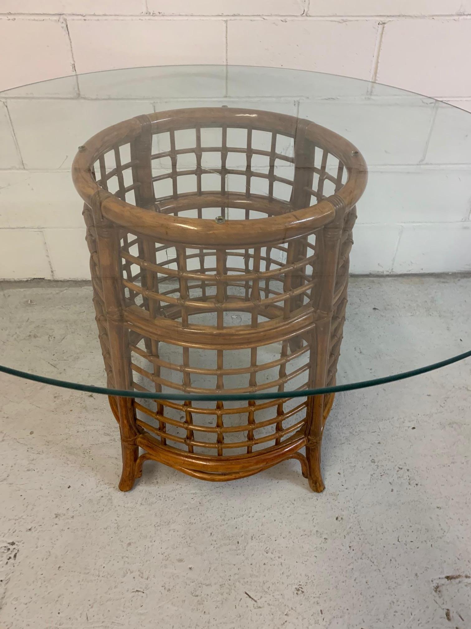 Midcentury rattan dining table features a rich, deep brown finish and a round glass top. Very good vintage condition with minor imperfections consistent with age.
Table measures 44