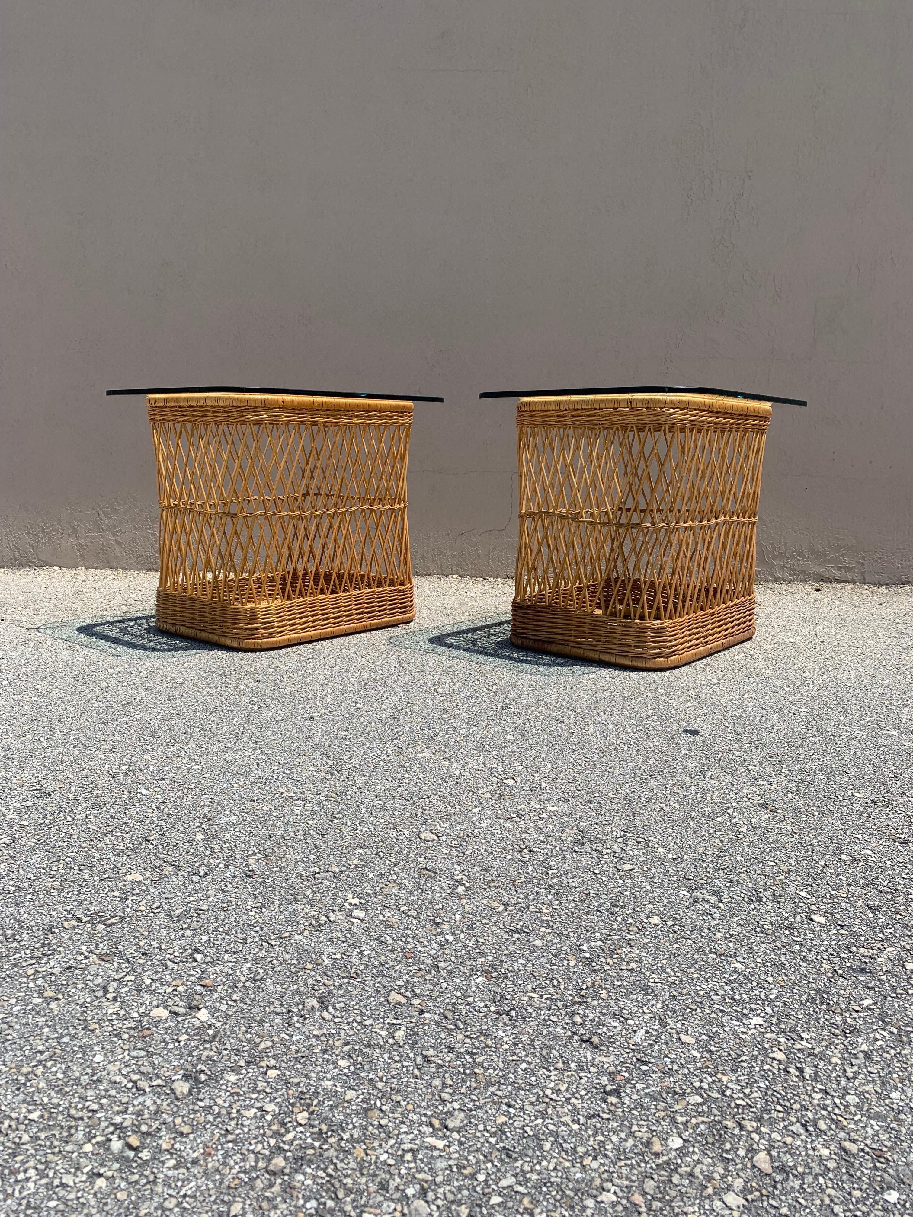 A pair of side tables designed by Davis Allen for McGuire of San Francisco. Made from rattan and cane, finished with a glass top. A delicate and handsome design, however the table itself is very sturdy. Design plays beautifully between the natural