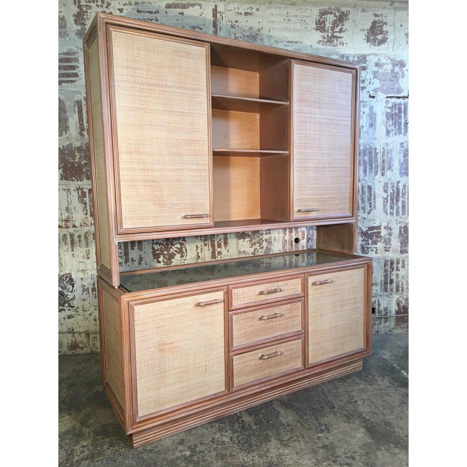 Vintage buffet with hutch features rattan door and drawer fronts and faux bamboo pulls. Credenza has glass top. Three drawers and ample storage behind four doors. Top hutch can be removed, and lower piece can be used as a server. Very good vintage