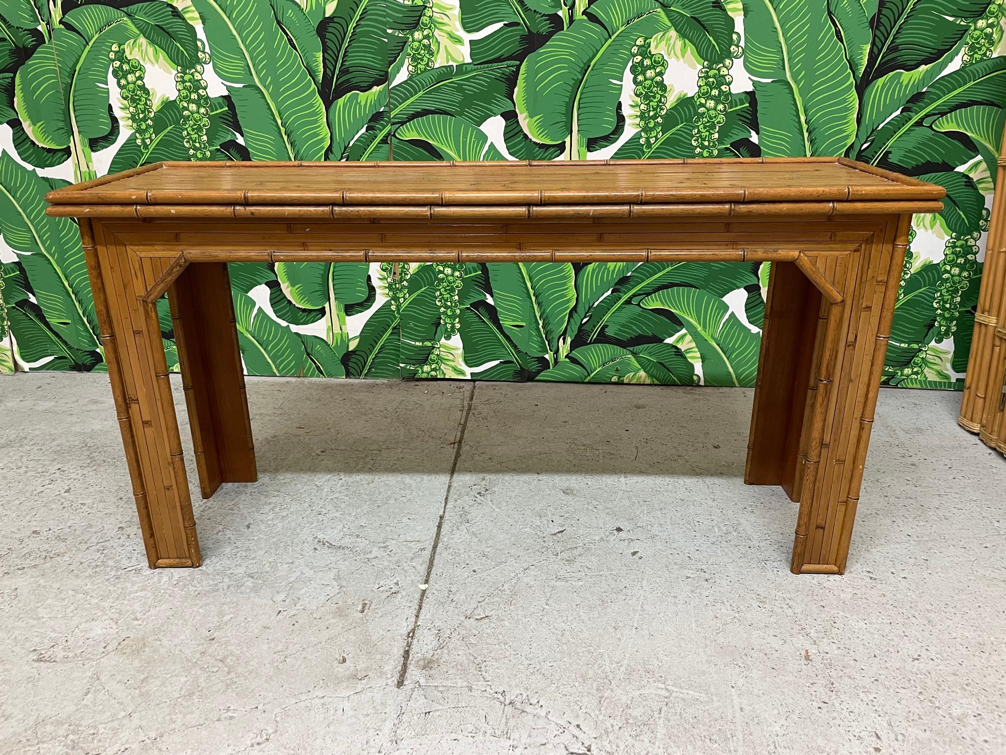 Vintage console/sofa table features a full veneer of split reed rattan and faux bamboo detailing. Very good condition with minor imperfections consistent with age.