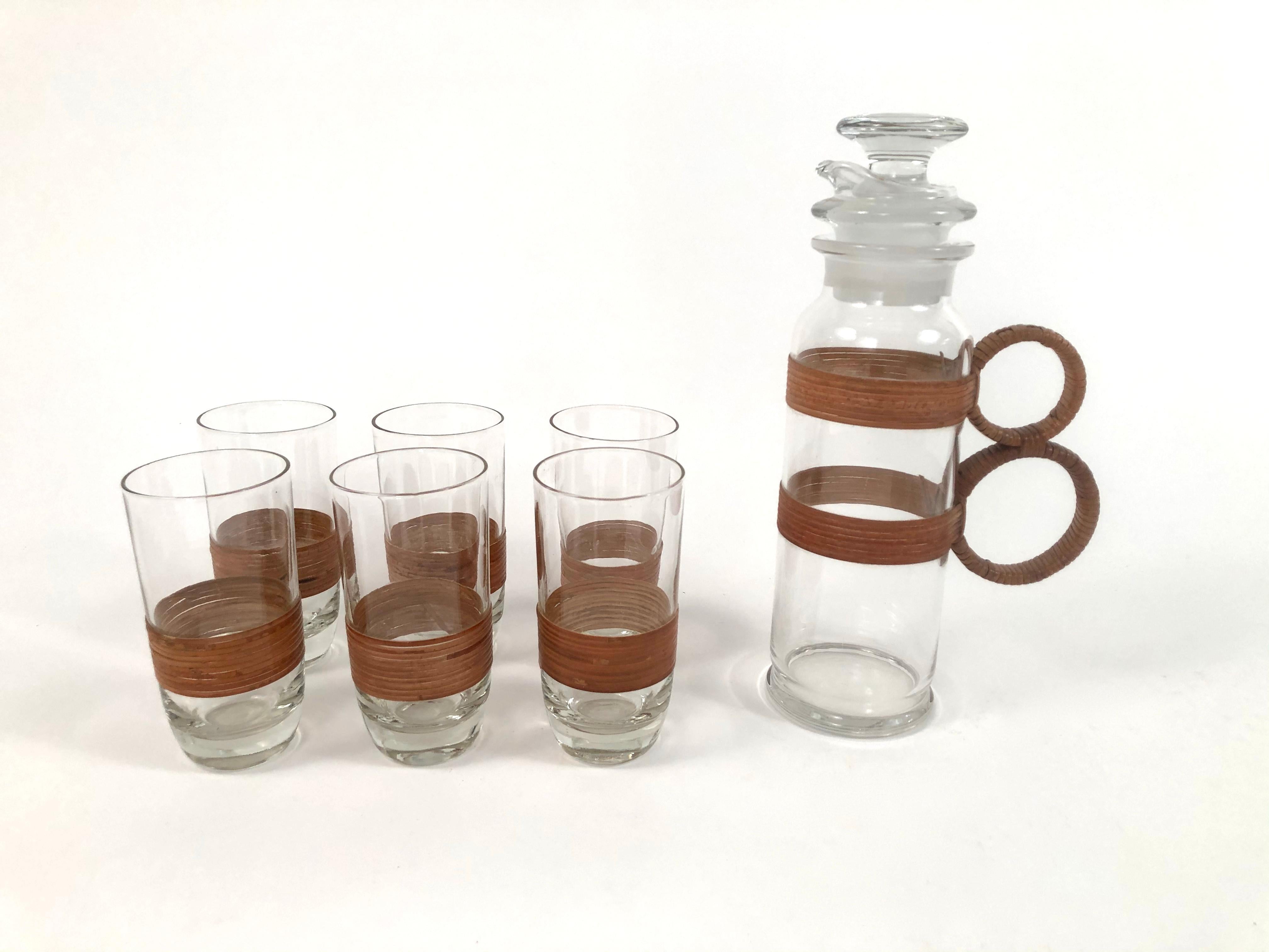 A stylish and beautifully made vintage highball set (also perfect for other cocktails, iced tea or lemonade) consisting of a rattan wrapped glass pitcher, complete with glass strainer and stopper, with a sturdy and comfortable to hold double circle