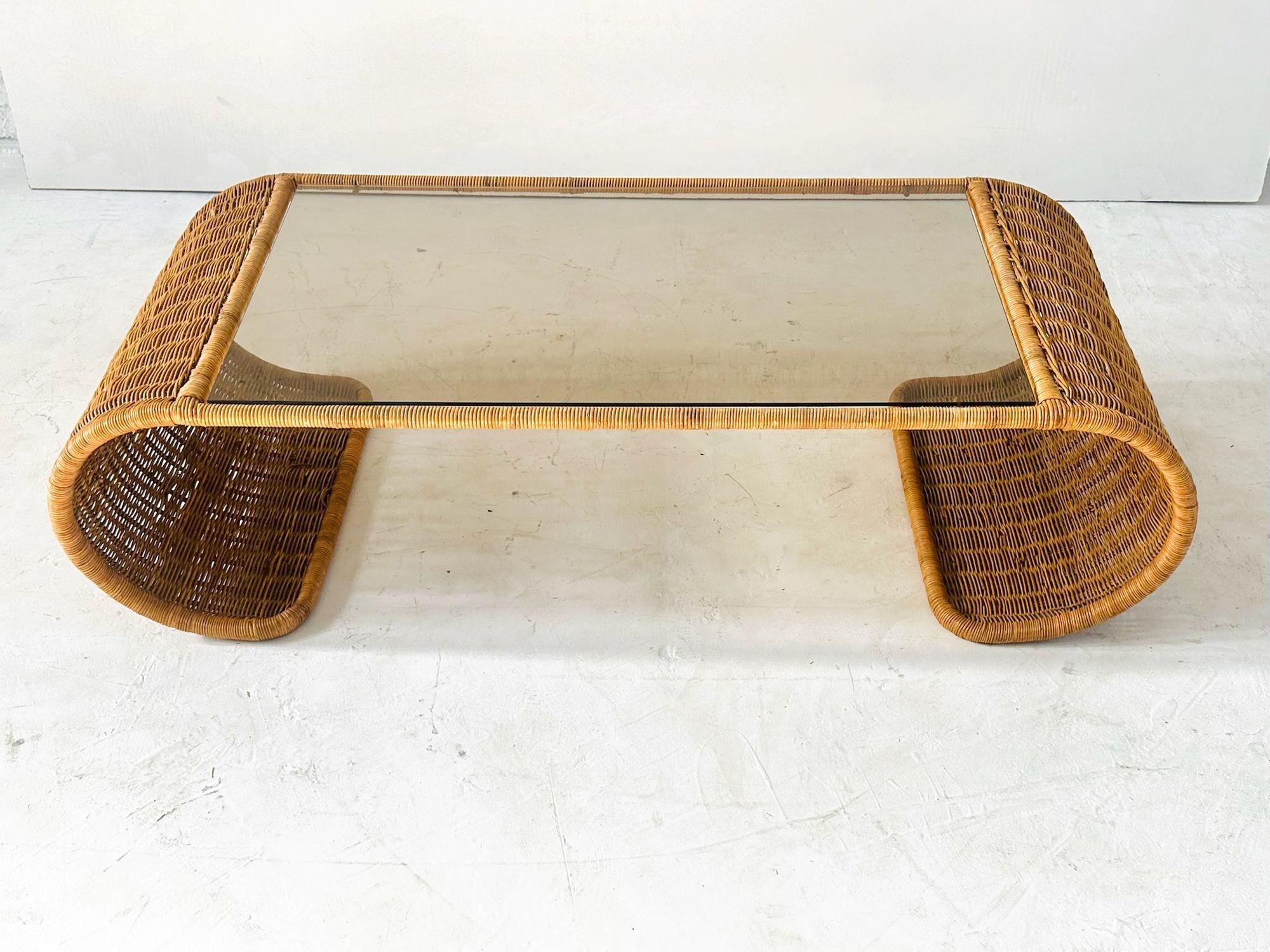 Rattan and Glass Waterfall  Coffee Table, 1970s.  Great condition.  Matching side/end table in separate listing.
Measures 15.25” tall 55” long 24” deep
