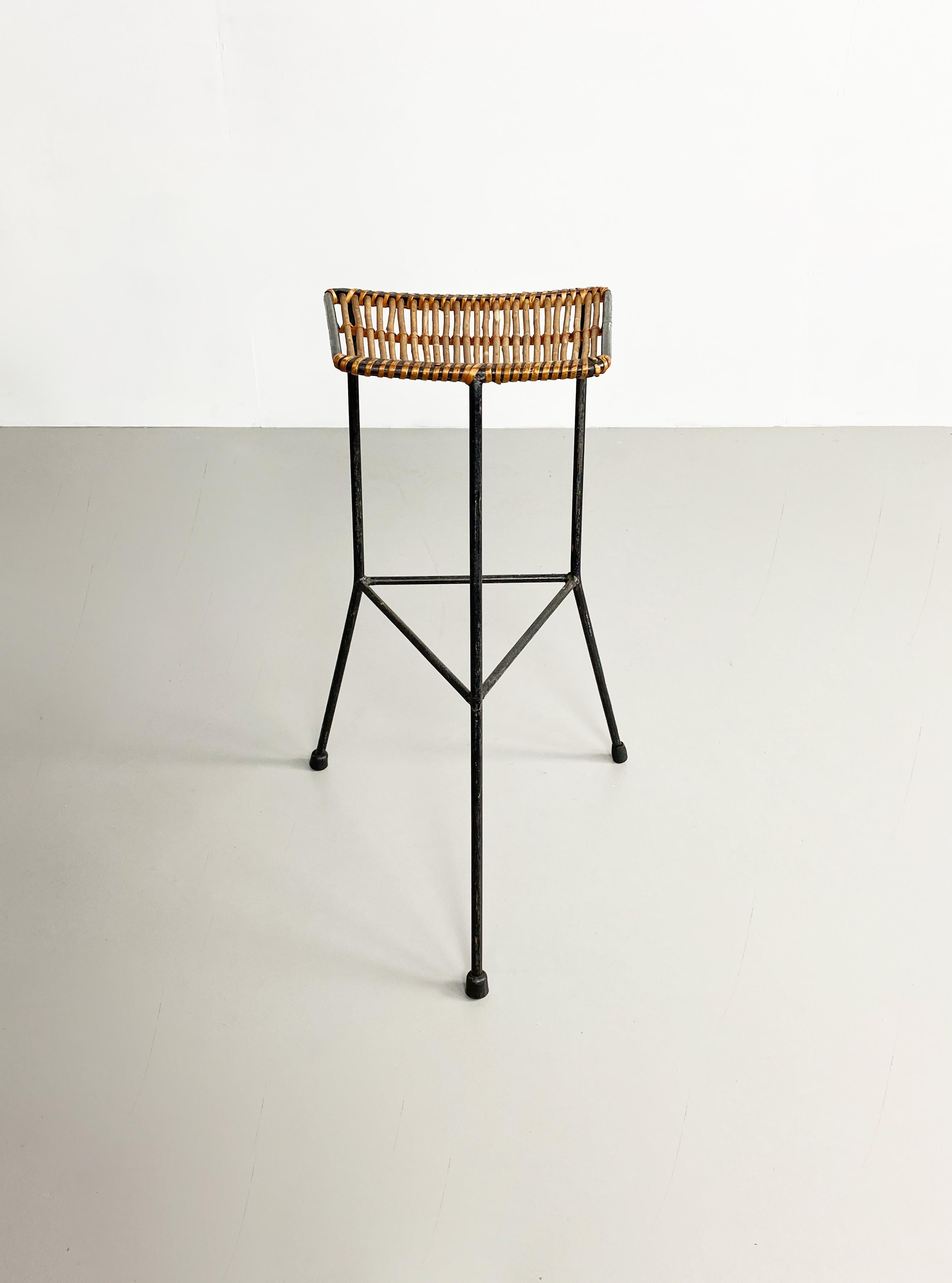 Rare three legged iron and rattan stool designed by Dennis Lennon in the 1950s.

Dimensions (cm, approx) 
Height: 70 
Width: 48 
Depth: 48