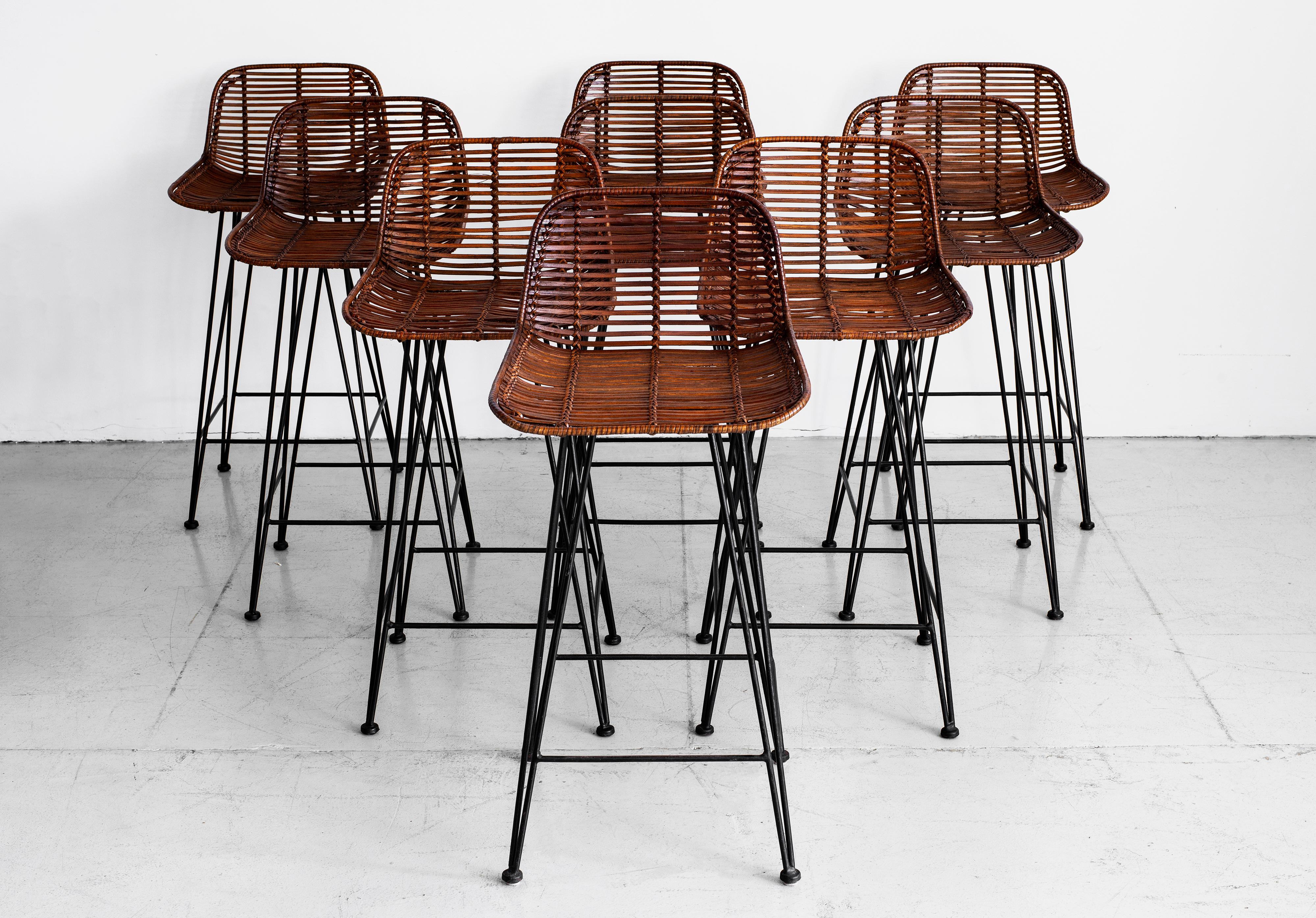 Unique rattan and iron barstools with angled black iron legs and slatted rattan curved seat with wicker.
Great patina and 9 available
Priced individually.