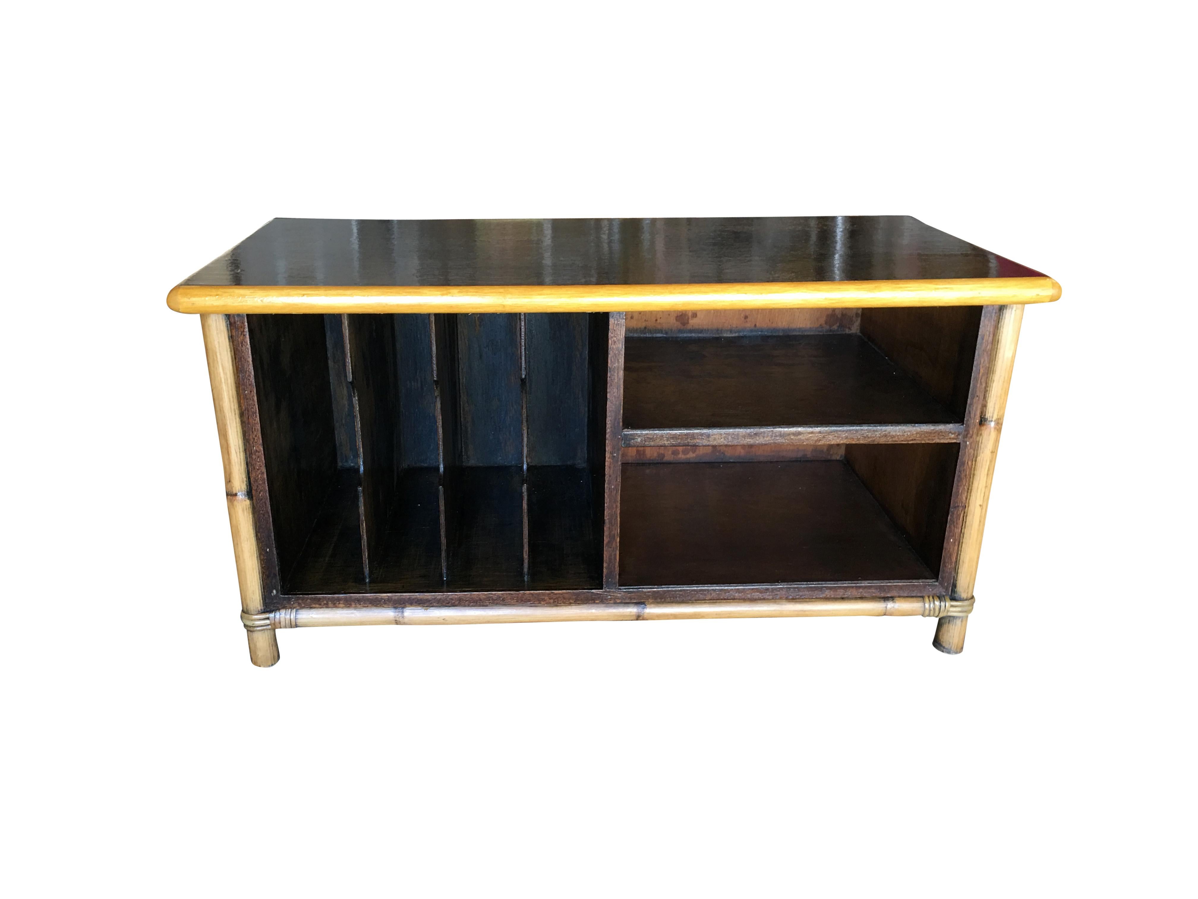 Rattan and mahogany TV stand made with adjustable shelf for holding two TV components and featuring four slots for holding vinyl records.

Great for holding modern 70