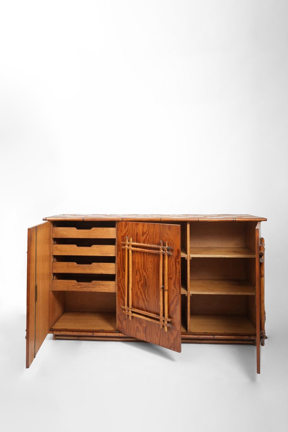 Rattan, oak and faux bois painted sideboard opening with three doors in the front. France, 1920s.