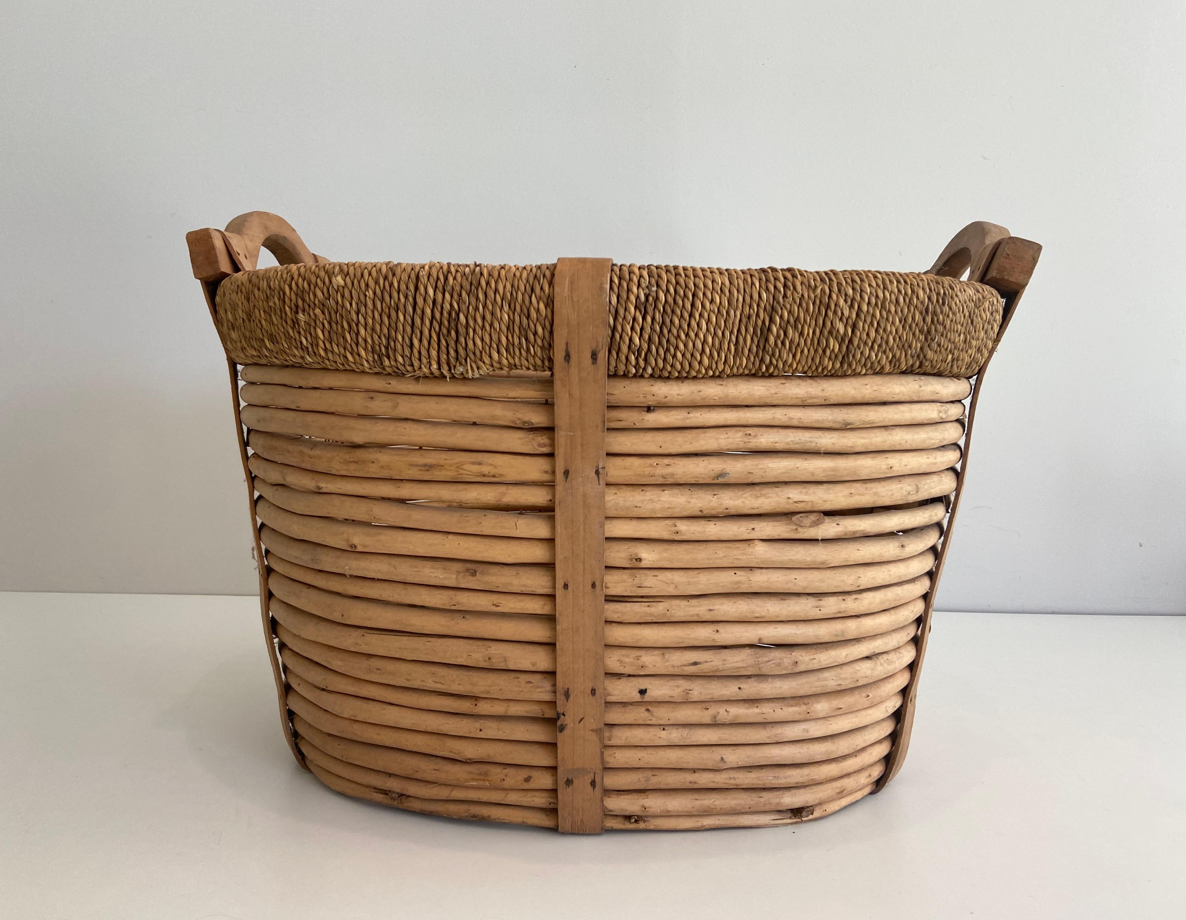 This logs basket is made of rattan, rope and wood. French work. Circa 1950.