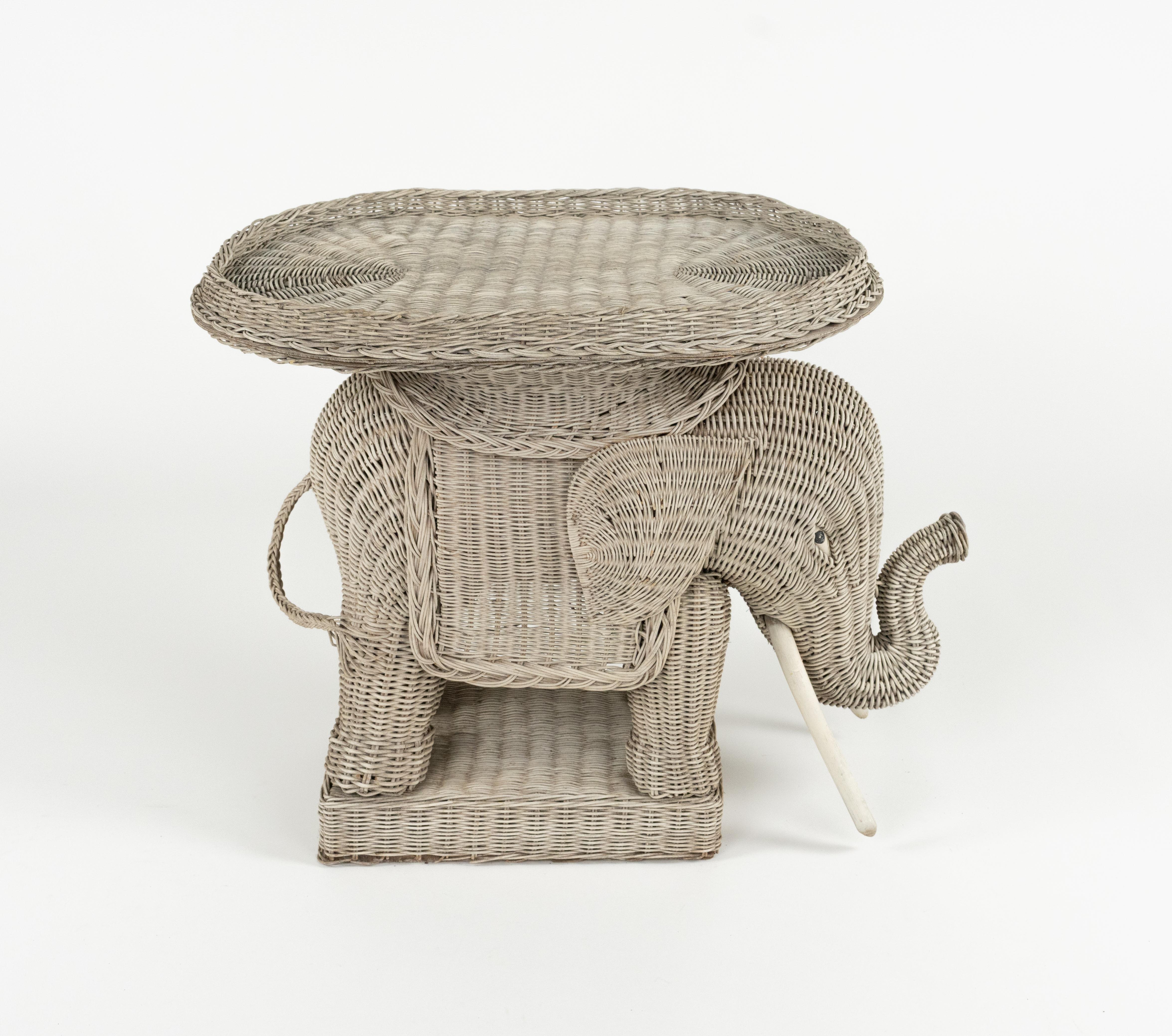 Erstaunlicher Couchtisch / Beistelltisch in Elefantenform aus handgeflochtenem Rattan mit Holzstoßzähnen im Stil von Vivai Del Sud.  

Außerdem hat er ein abnehmbares Tablett aus Weidengeflecht.  

Hergestellt in Italien in den 1960er Jahren. 