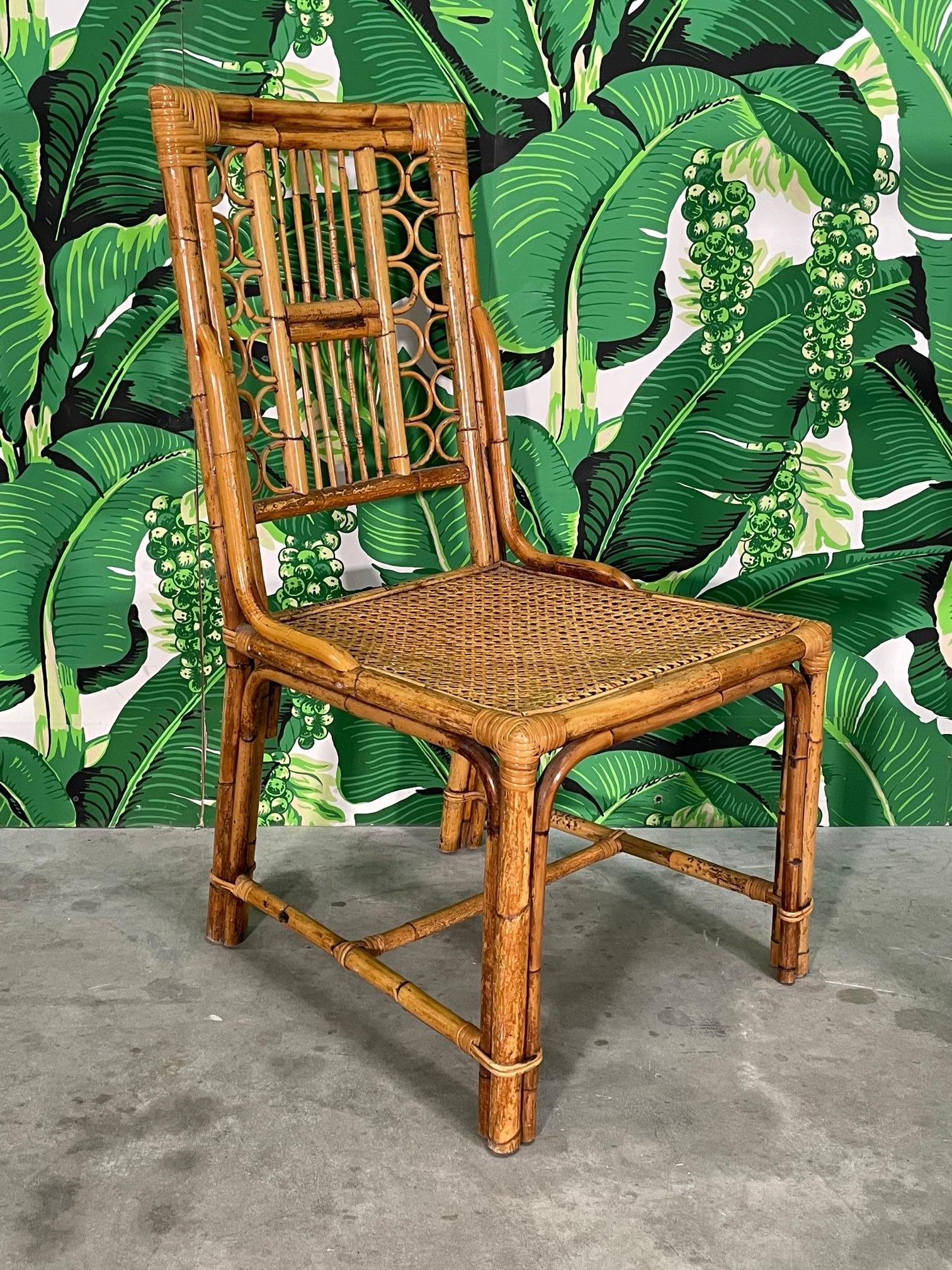 Set of six rattan dining chairs feature detailed fretwork and cane seats. Good condition with imperfections consistent with age. May exhibit scuffs, marks, or wear, see photos for details.

  