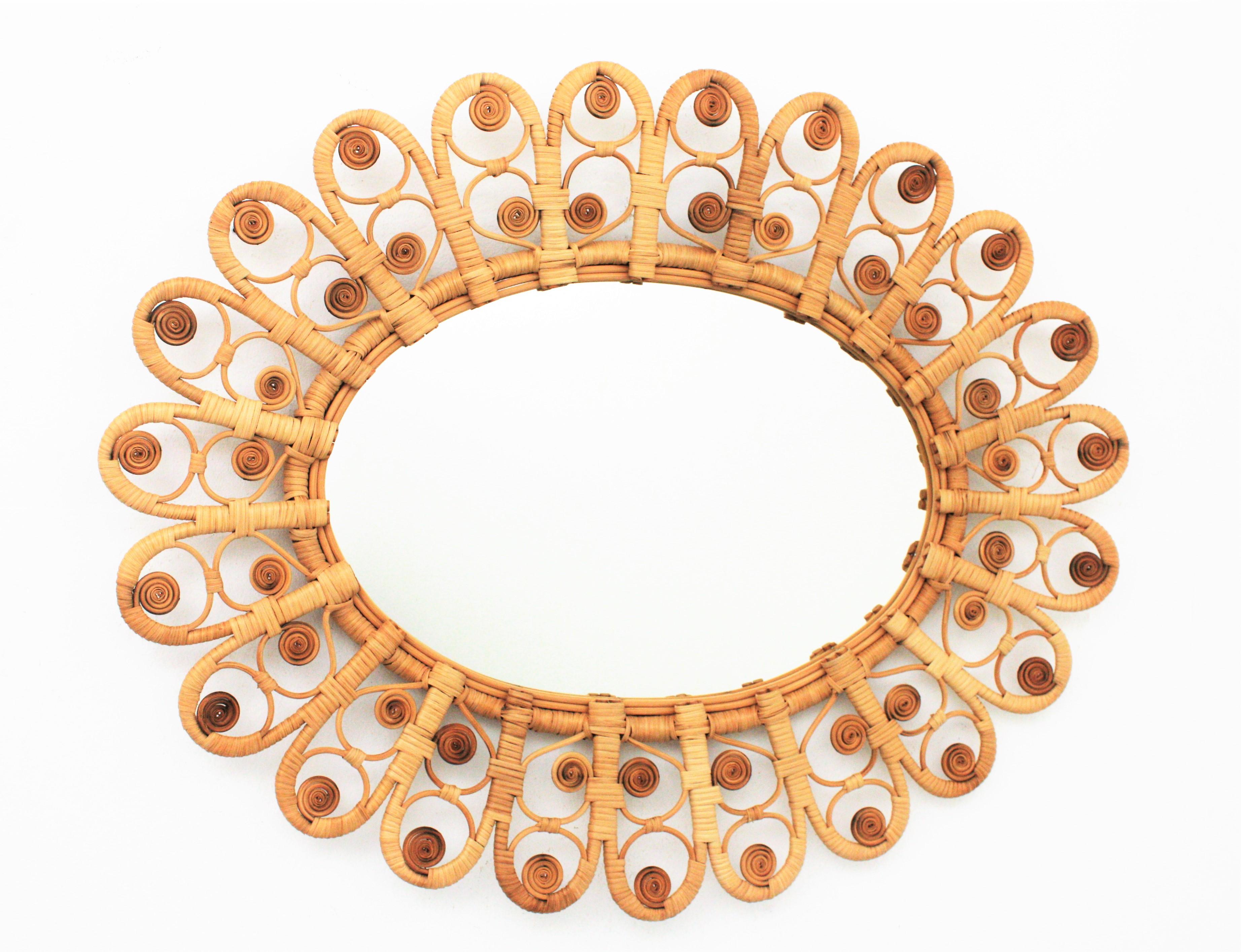 Large oval shaped handcrafted wicker and rattan mirror with a beautiful artistic filigree peacock frame, Spain, 1960s.
This mirror has all the taste of the Mediterranean and bohemian style and reminiscences of the design of the Peacock chairs.
All