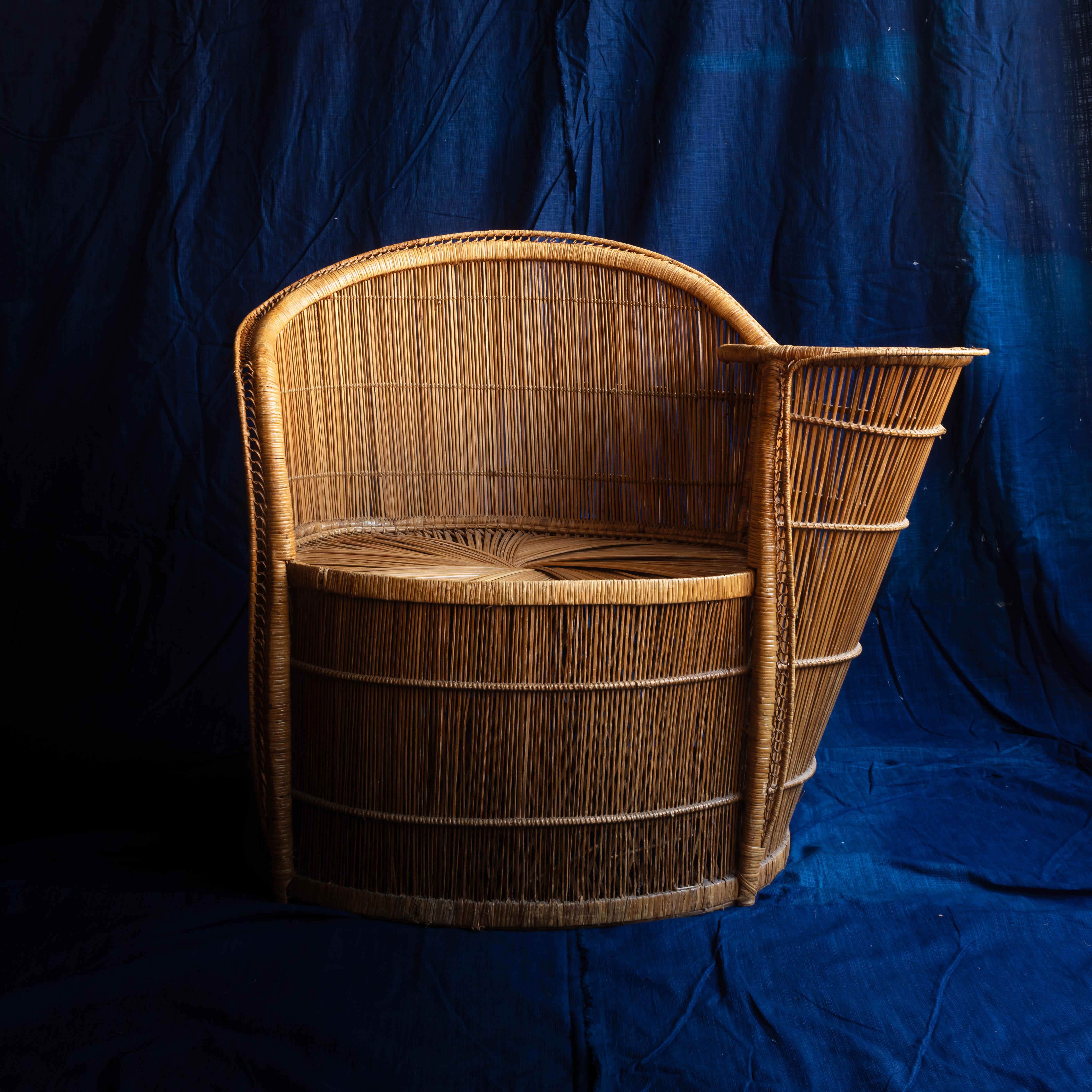 Charming rattan armchair with integral side table.
French c1960s 
Dimensions: Height: 78 x Width: 99 x Depth: 50cm