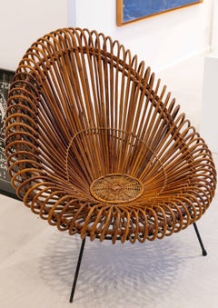 Rattan armchair with metal legs