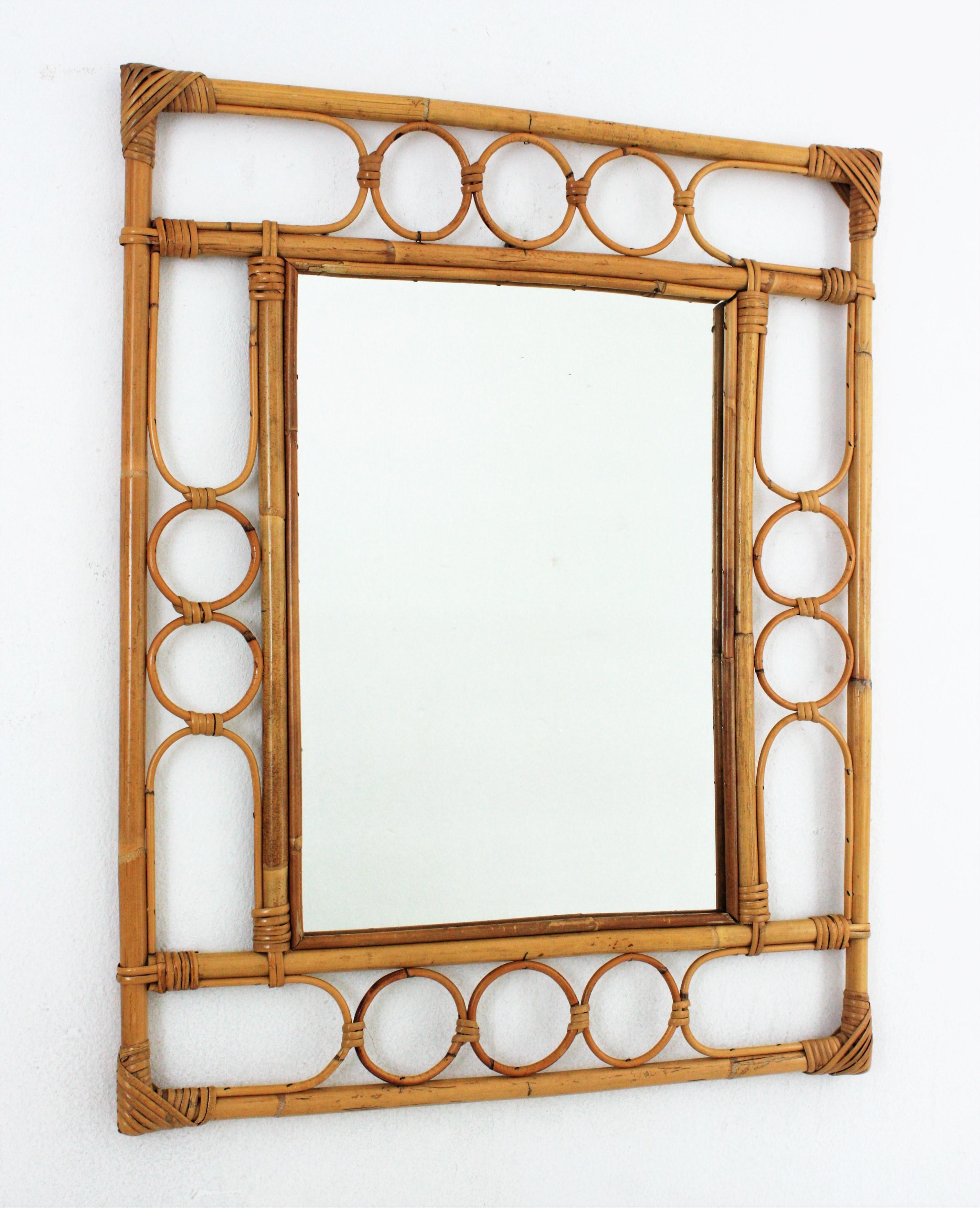 Eye-catching Mid-Century Modern Franco Albini style handcrafted bamboo and rattan mirror. Italy, 1960s.
This mirror features a double bamboo rectangular frame with geometric rattan decoration between the bamboo canes.
This bamboo mirror will be a