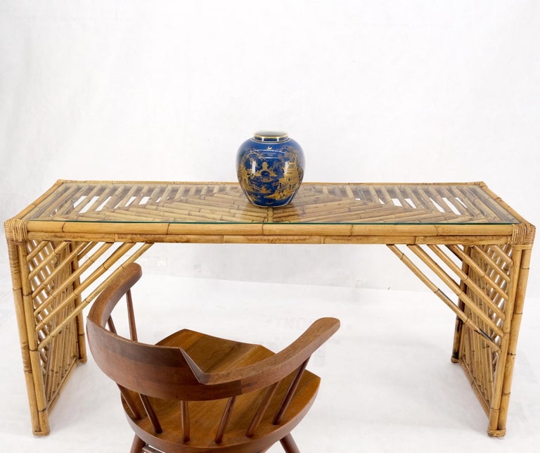 Rattan bamboo glass top console sofa table.
Ficks Reed, McGuire decor match.