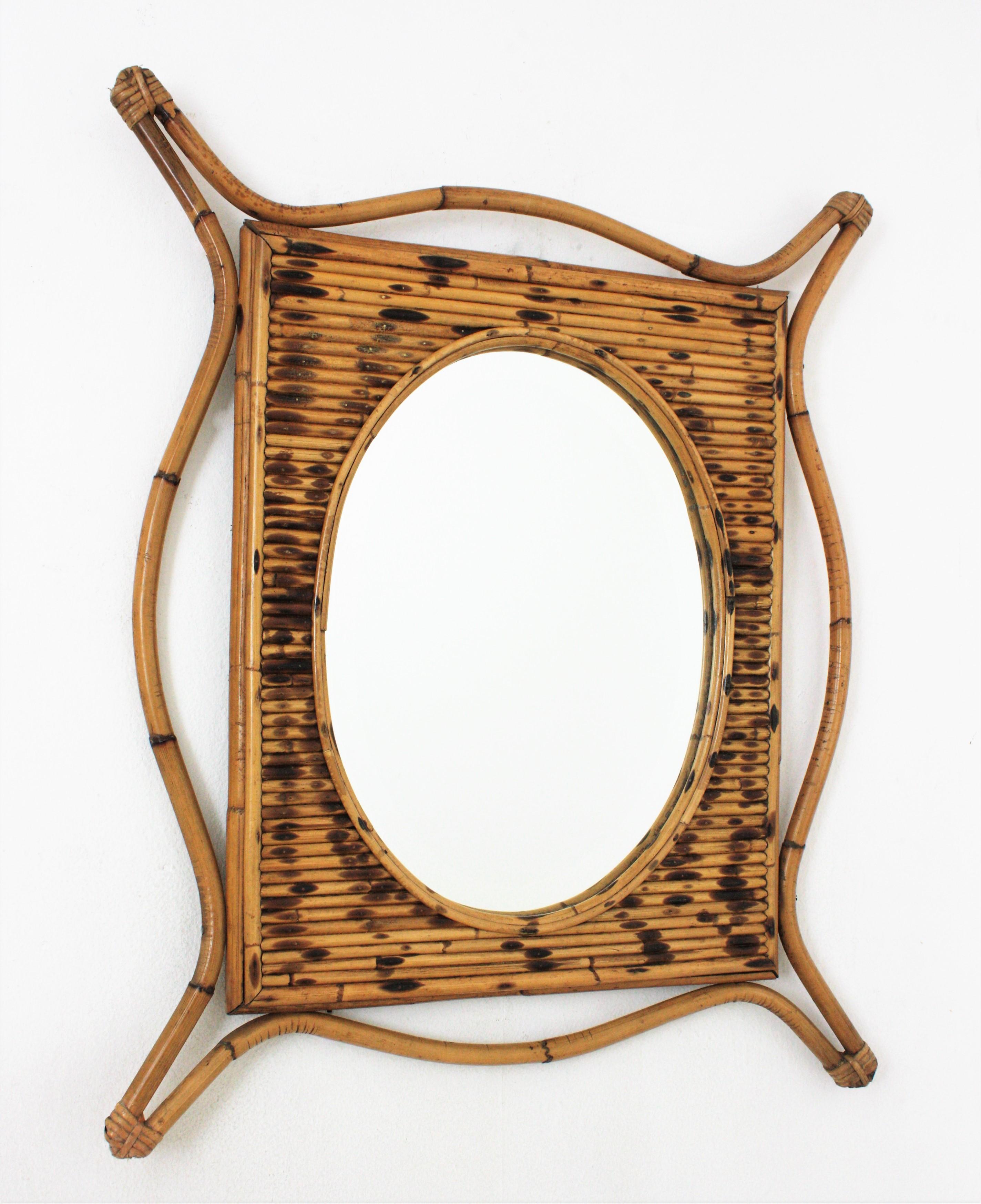 Handcrafted rattan bamboo split reed mirror. Spain, 1960s.
This mirror features a beautiful artistic frame entirely handcrafted in bamboo and rattan. The central part surrounding the oval mirror features a split reed frame with pyrography details.