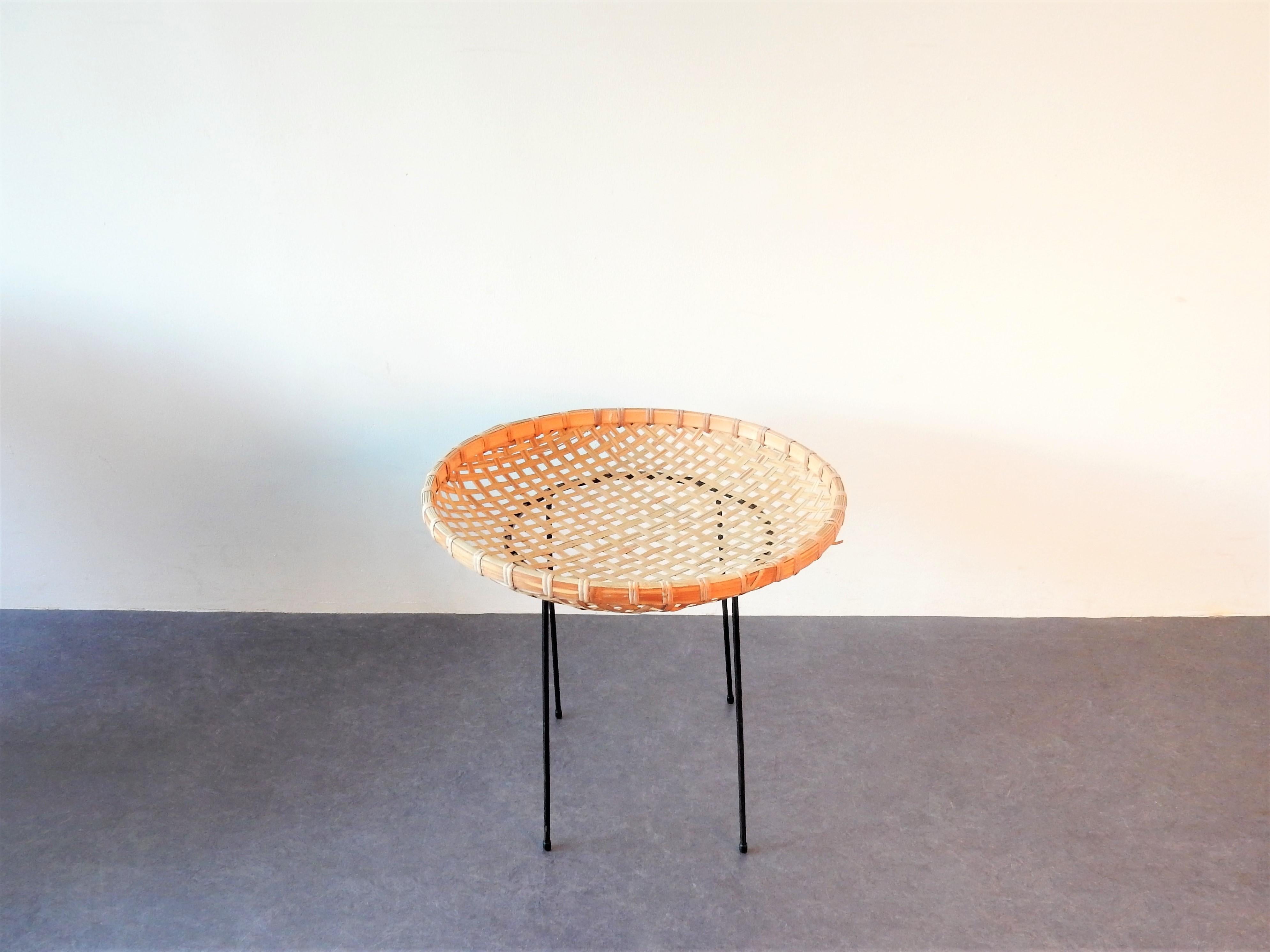 This rattan magazine basket stand was manufactured by the Dutch company Artimeta. It has a braided rattan magazine basket on a black metal stand. An elegant and minimalistic design. It is in a good condition with a small cut to 1 piece of the rattan