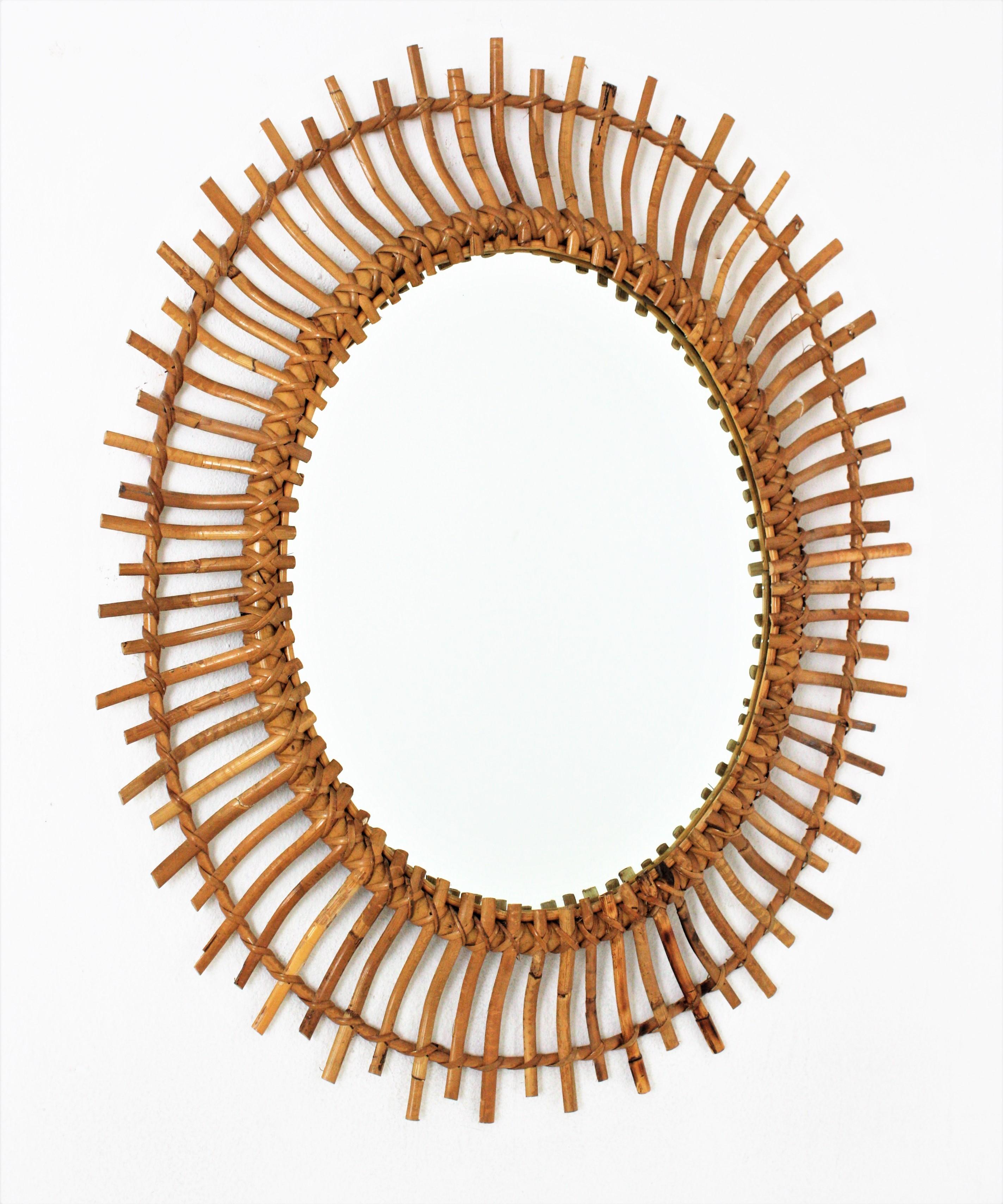 Amazing bamboo and rattan sunburst oval mirror. Handcrafted in Spain, 1960s.
It has all the taste and freshness of the Mediterranean Coast.
Lovely placed alone or as a part of a rattan mirrors wall composition.
This rattan oval mirror is the