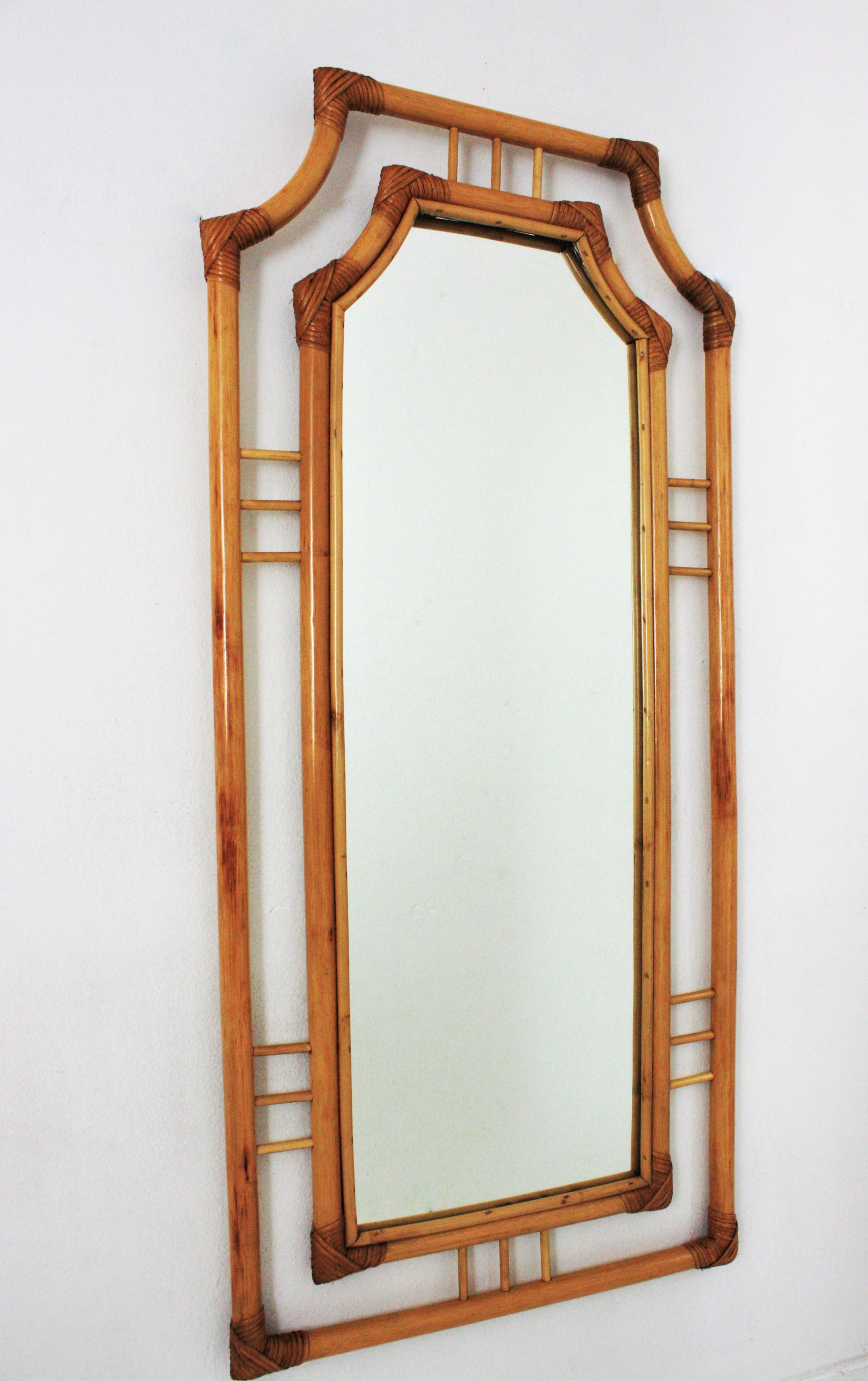 Mid-Century Modern bamboo and rattan pagoda style rectangular mirror with oriental accents, Spain, 1960s.
This tall wall mirror will be eye-catching in a dressing room, bedroom or bathroom. Place it in a beach house, countryside house or urban