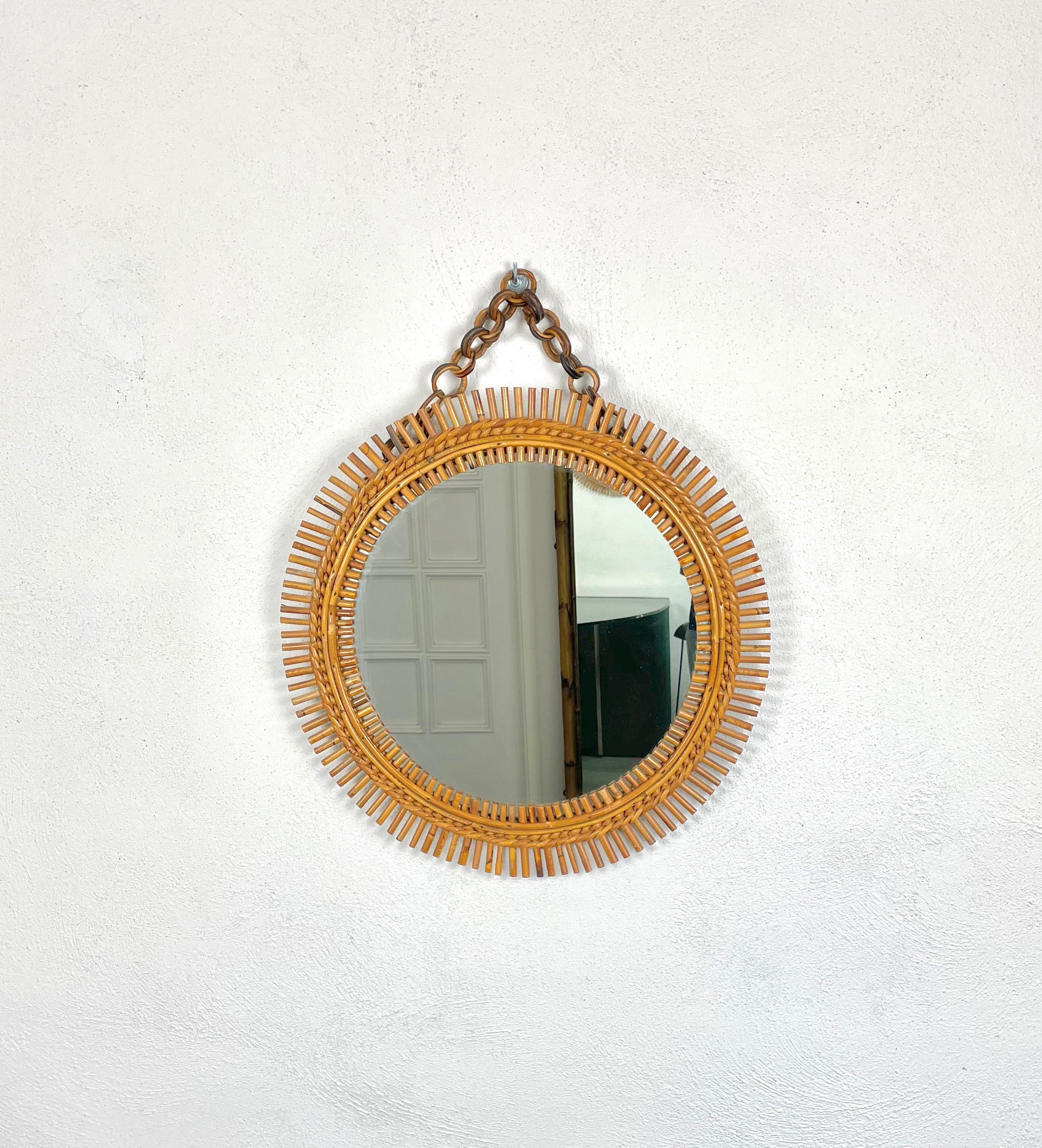 Round wall mirror with rattan bamboo frame made in Italy in the 1960s.
