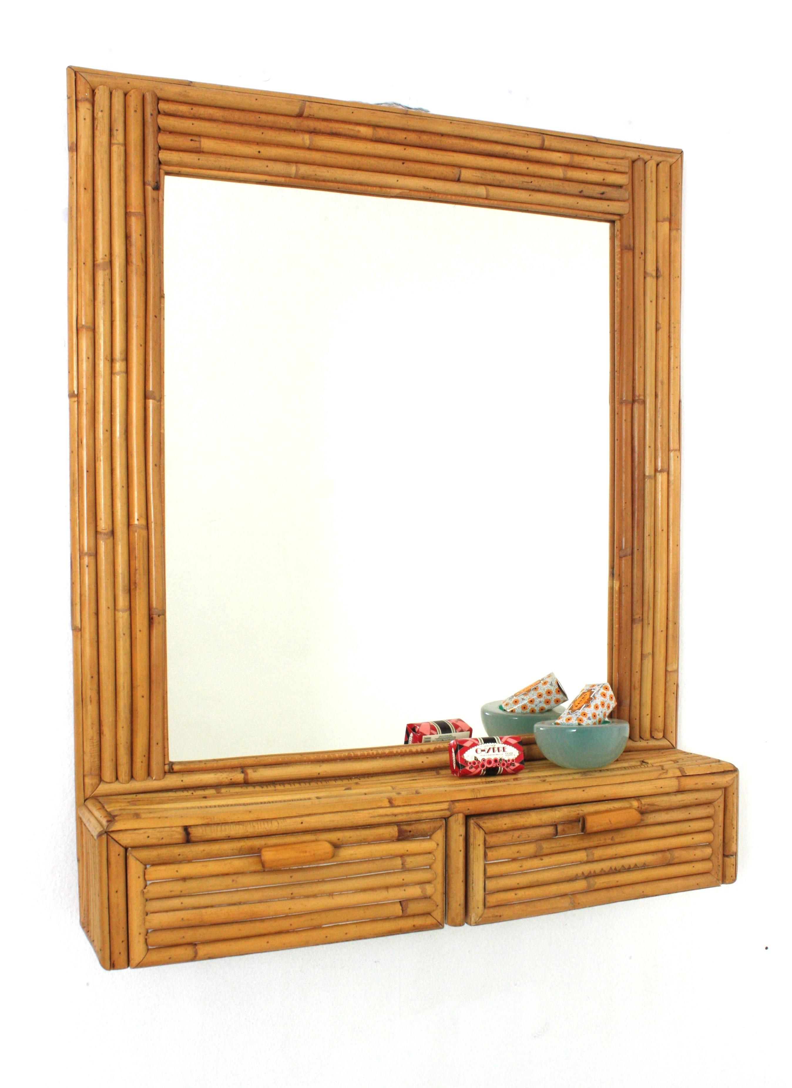 Midcentury Rectangular wall mirror with shelf, split reed, bamboo, rattan, Italy, 1960s.
This eyecatching mirror with storage drawers was handcrafted with bamboo cane and rattan.

It will be a nice addition to be used in a bathroom or as wall mirror