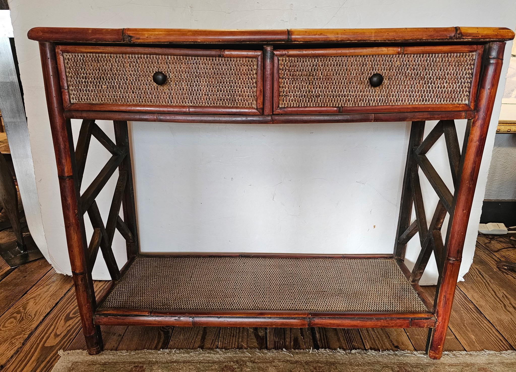 Great looking bamboo and rattan console sourced in Nantucket, having two drawers and second bottom tier.