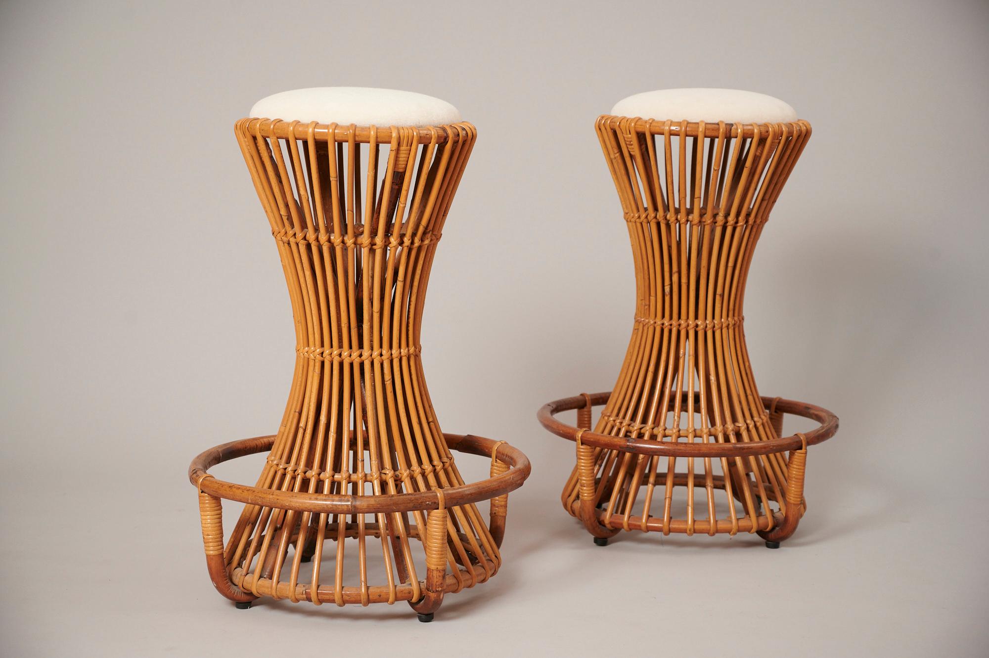 Rare bar stools in rattan by Tito Agnoli for Bonacina c1955.

Structurally sound and in good usable condition. Seats have been upholstered in an off white alpaca velvet.
