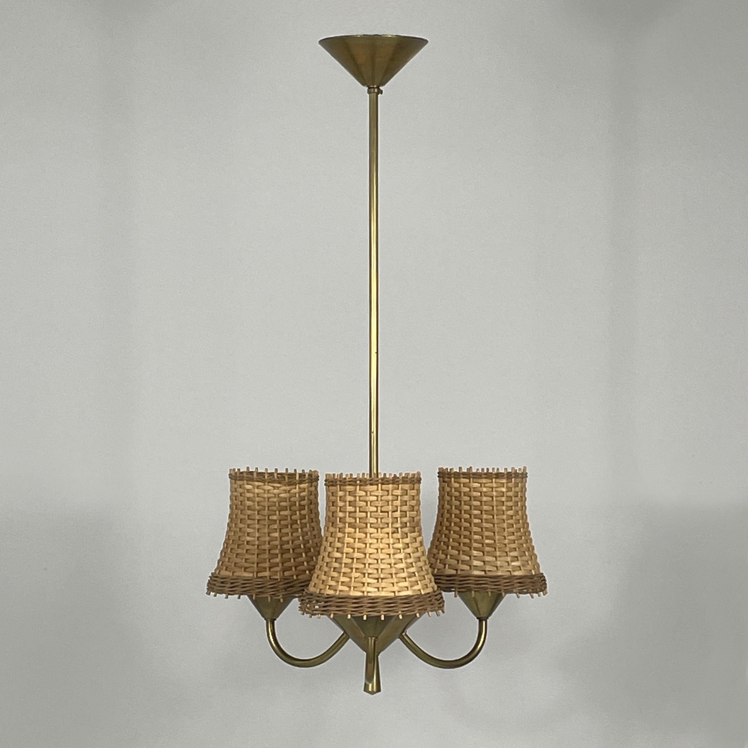 This unusual mid-century 3-light chandelier was designed and manufactured in Austria in the 1950s in the manner of JT Kalmar or Rupert Nikoll. 

The light features a brass metal frame with a central stem extending downwards. It has three arms, each